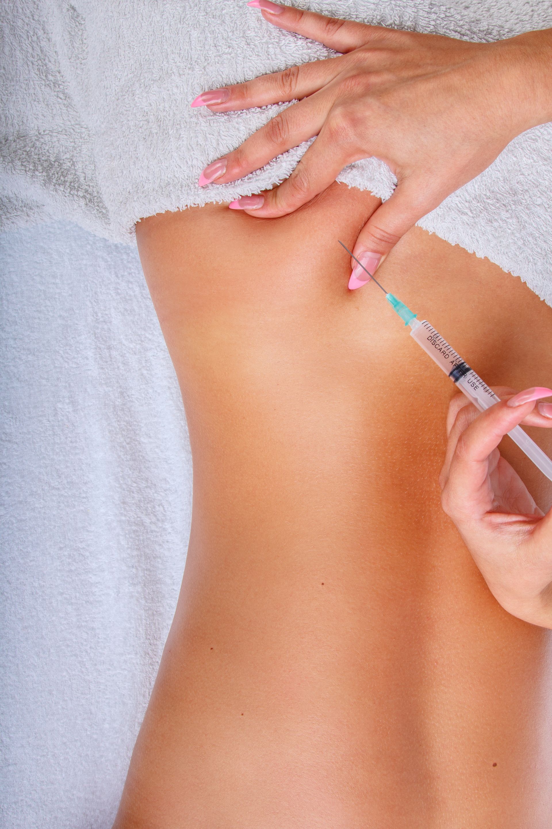 a woman is getting an injection in her back with a syringe