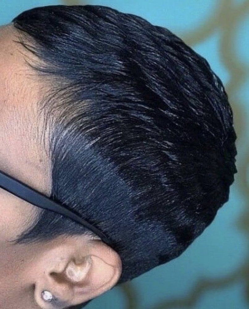 A close up of a woman 's head with short hair and glasses.