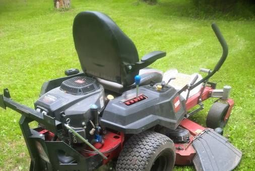 a toro zero turn lawn mower is parked in the grass