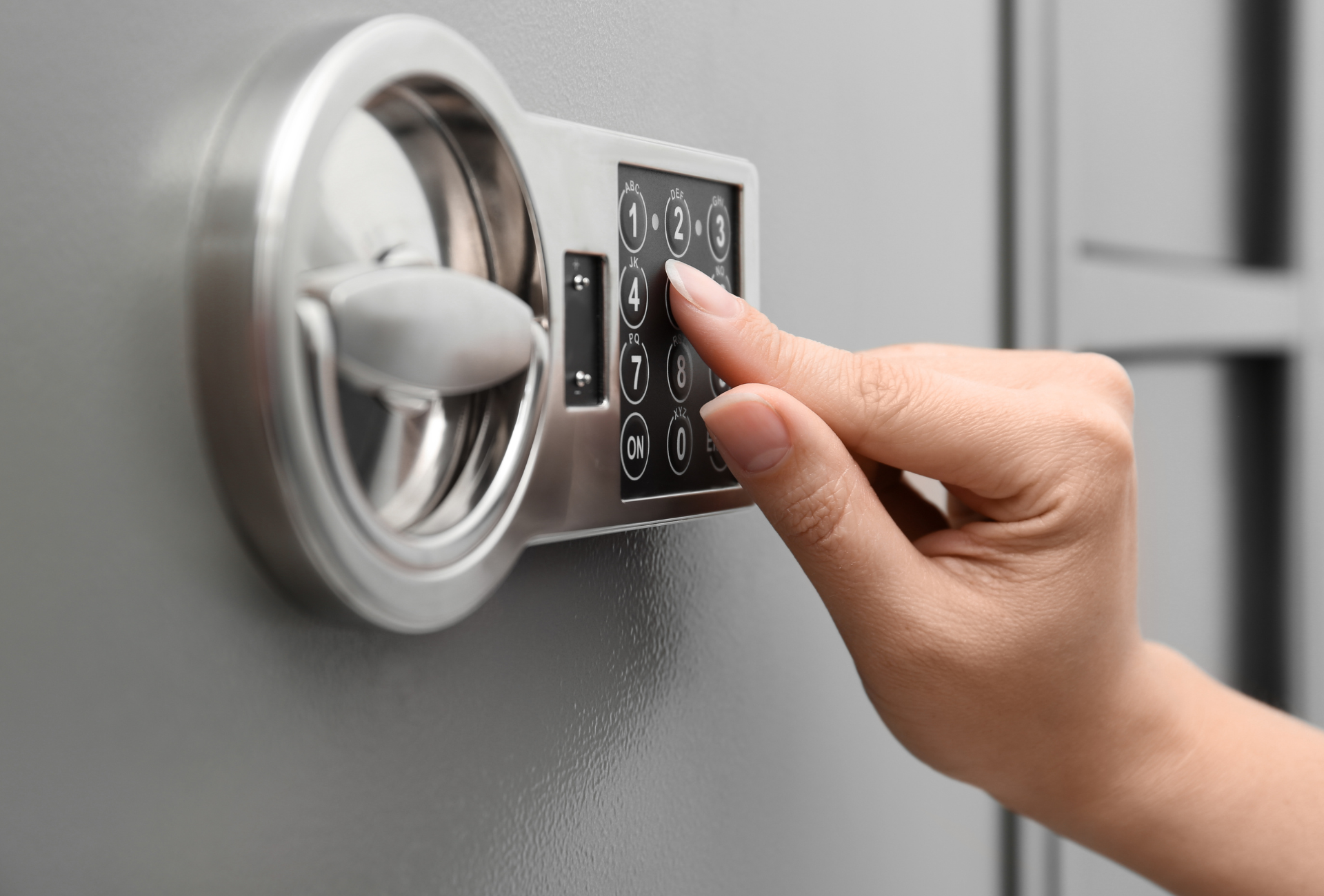 A person is using a keypad to open a safe.