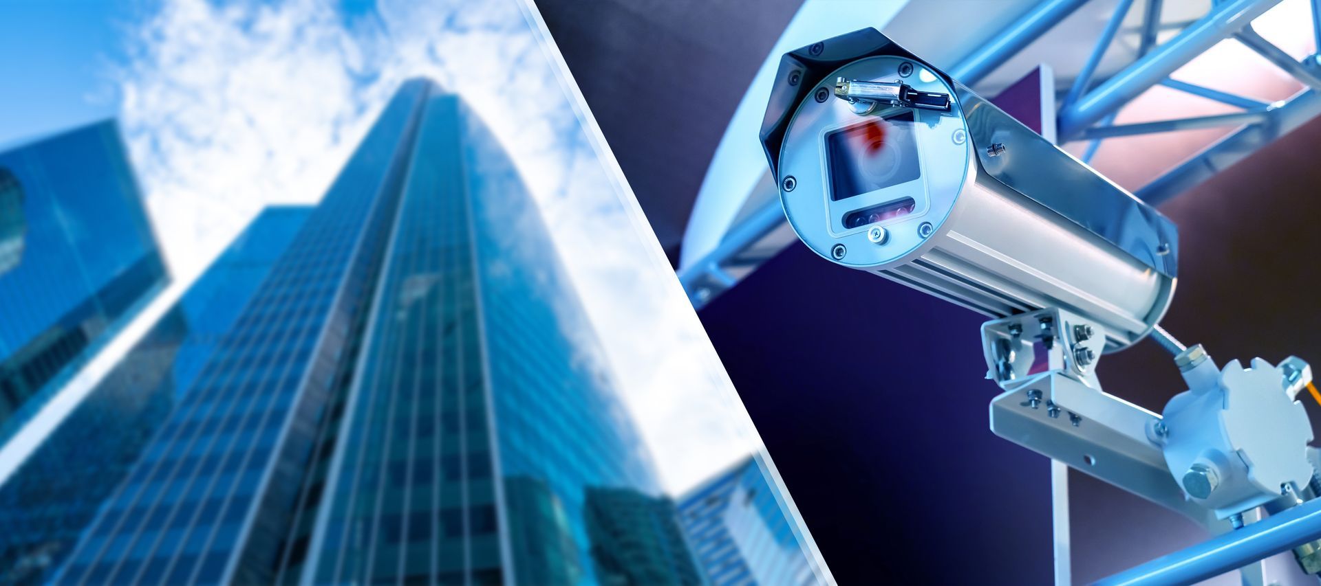 A person is installing a security camera on a wall with a drill.