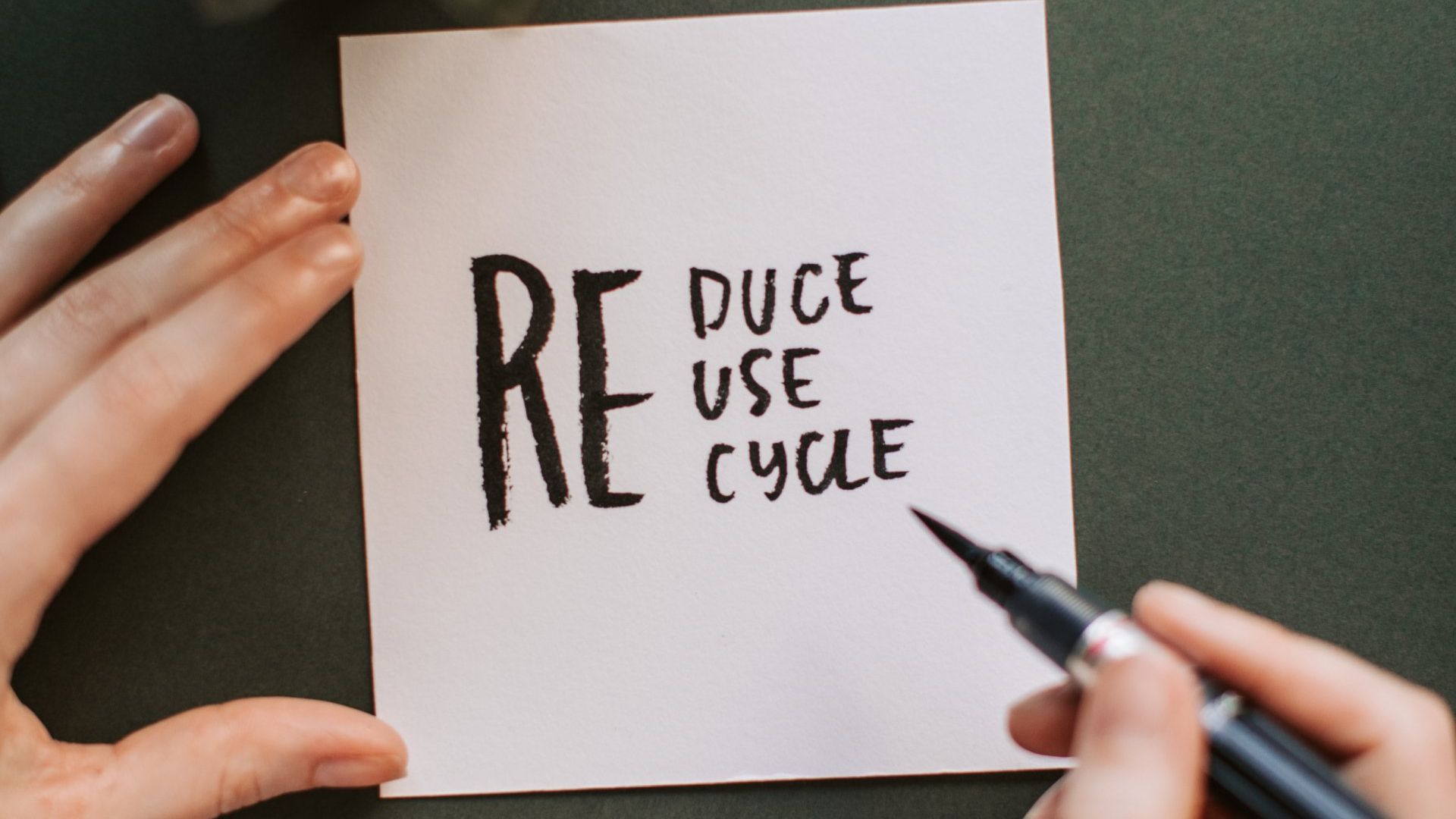 Reduce Re Use Re Cycle written on note