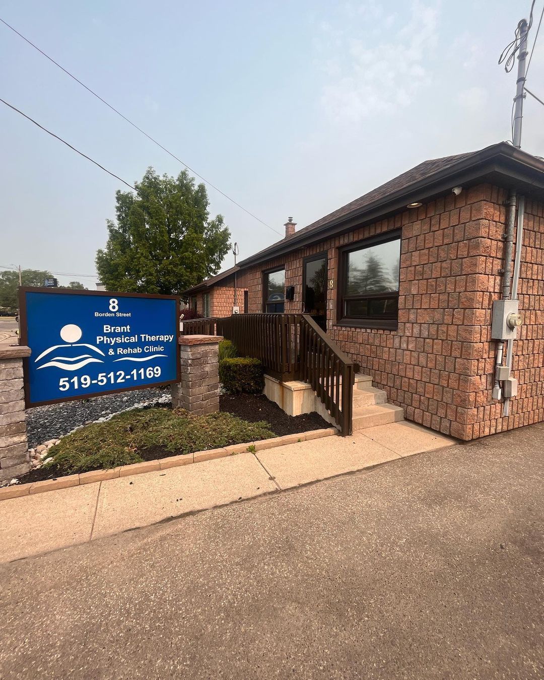 A brick building with a blue sign in front of it.