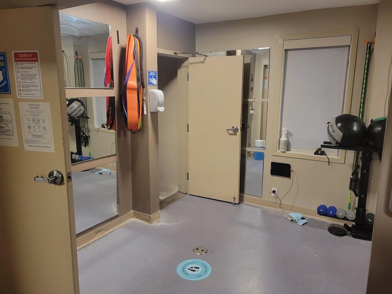 A room with a lot of mirrors and a door.