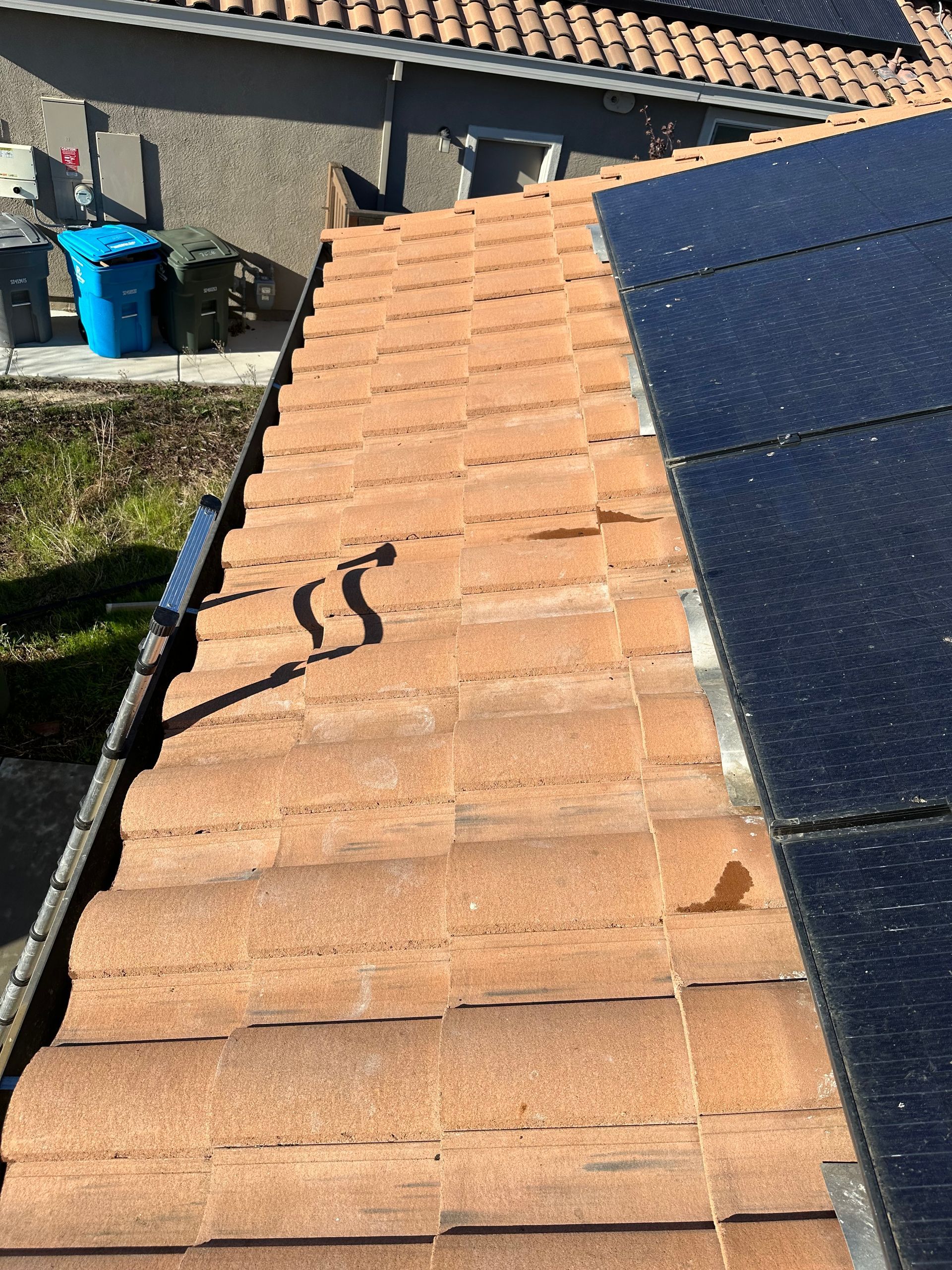 A roof with a few solar panels on it