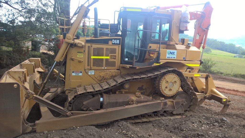 A Bulldozer Is Parked On The Side Of A Dirt Road — ACC Excavations & Demolition Pty Ltd In Ulladulla, NSW