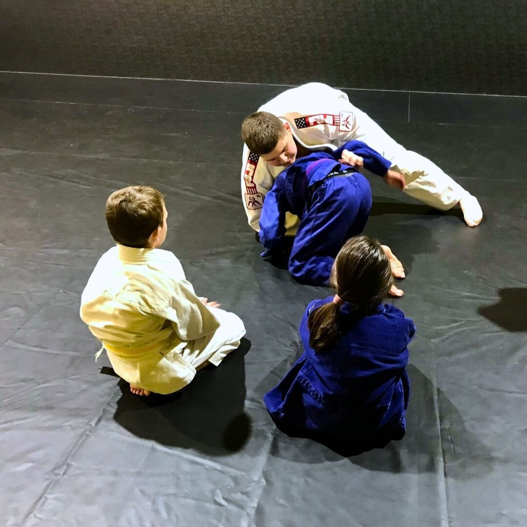 Four men in athletic gear, posing for a photo in a gym.