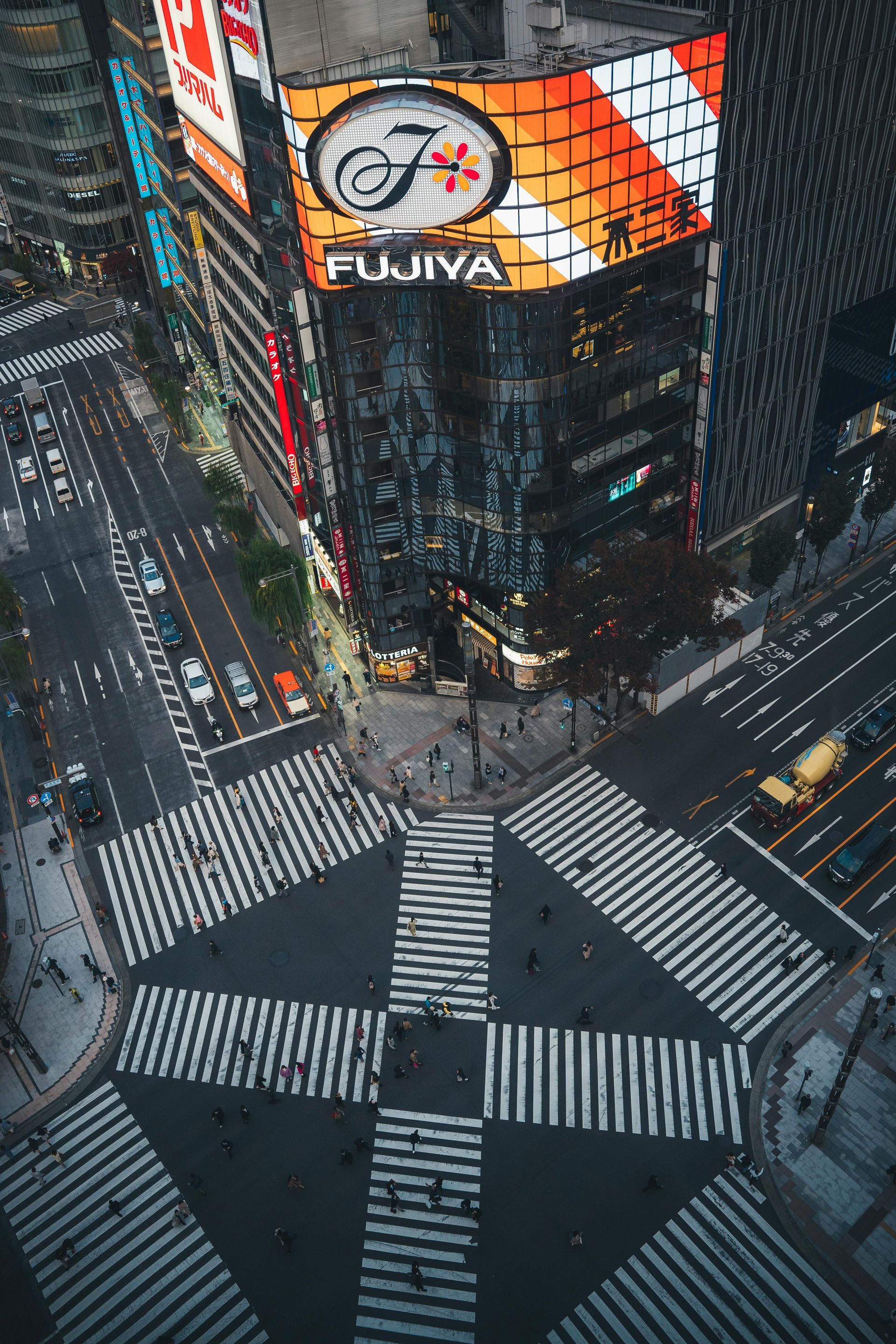 High-angle shot of Tokyo intersection with pedestrian crossing and the FUJIYA building.