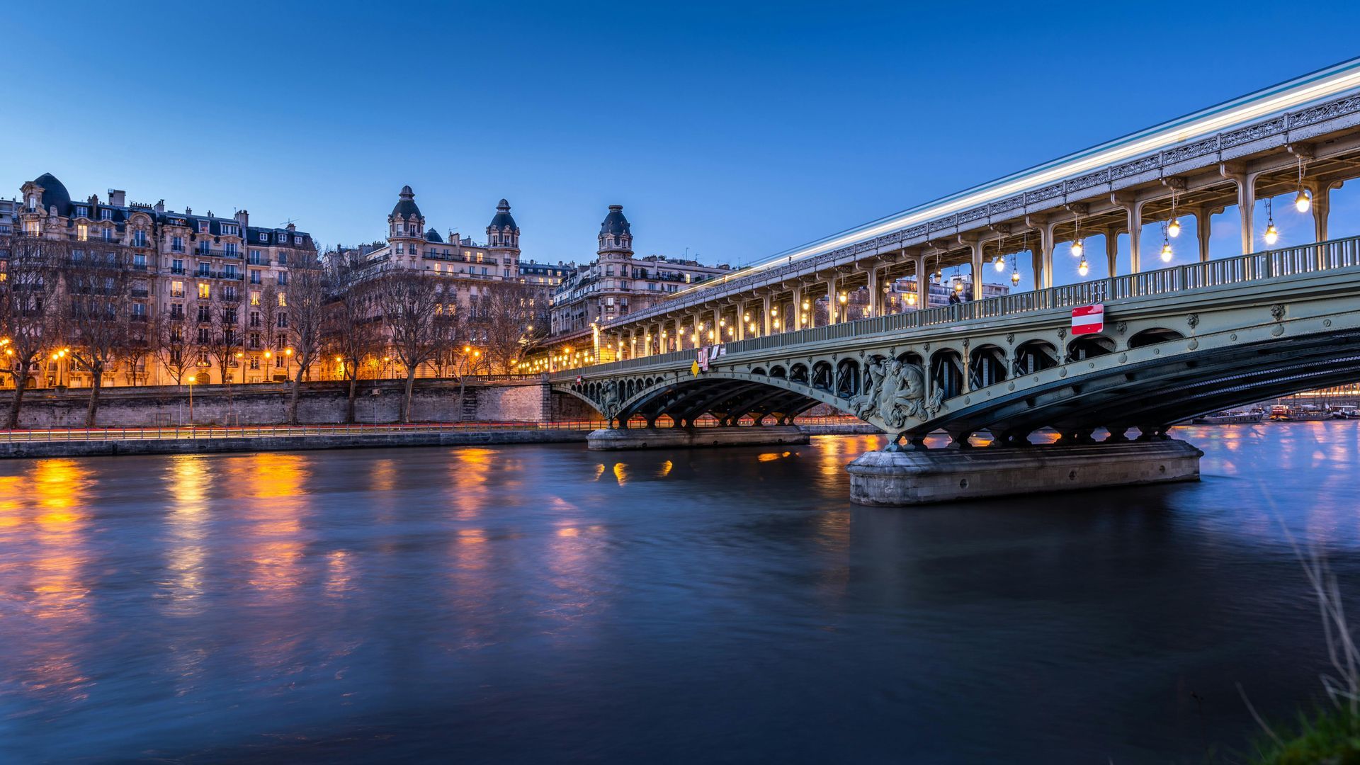 Pont de Bir-Hakeim bridge over the Seine river at dusk in Paris, France.