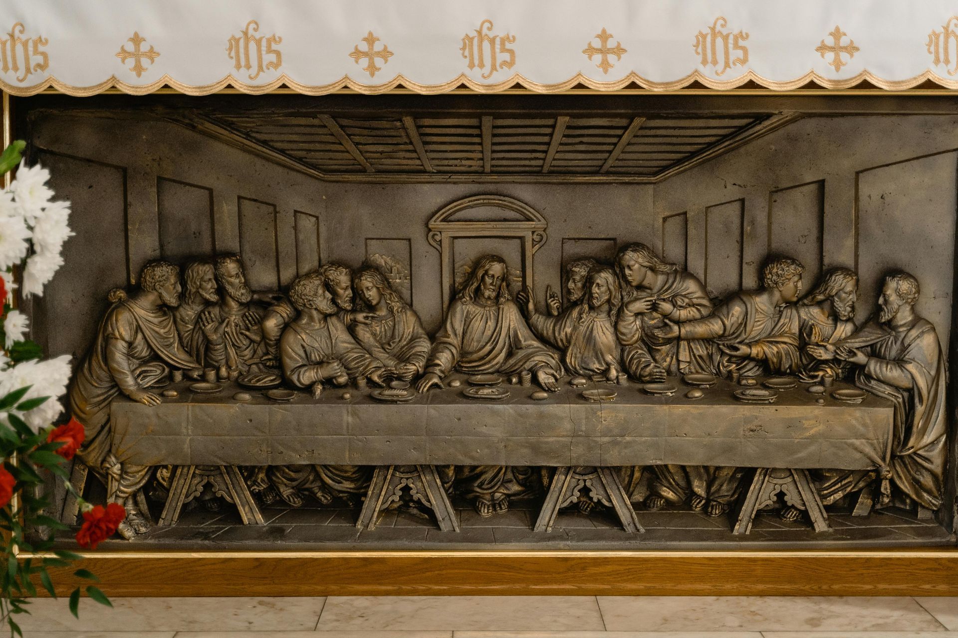 Relief sculpture of the Last Supper, Jesus with his disciples at a table.
