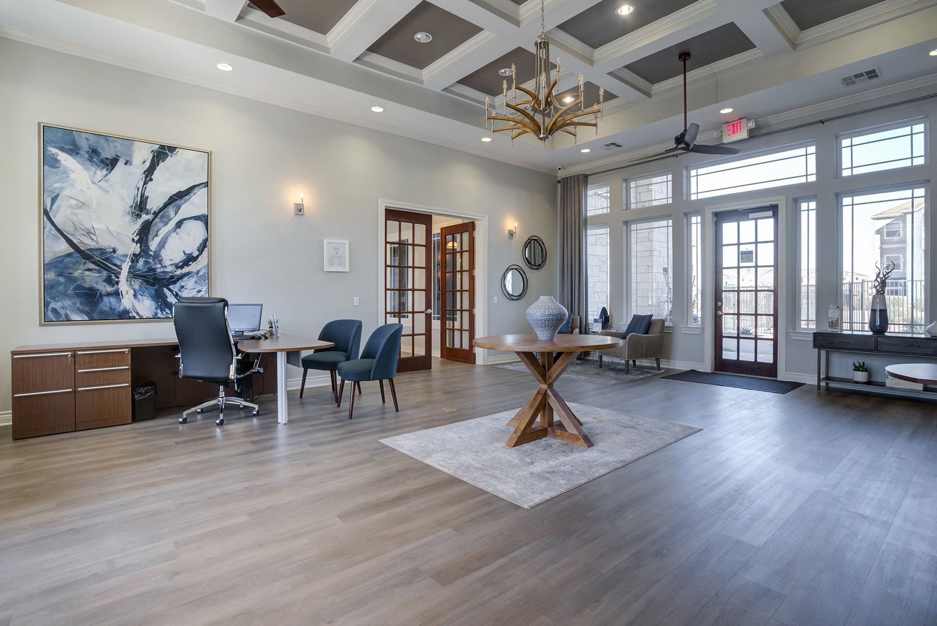 Leasing Office and Clubhouse with White Armchairs on Area Rug with Coffee Tables at Residence at Midland, Midland, 79706