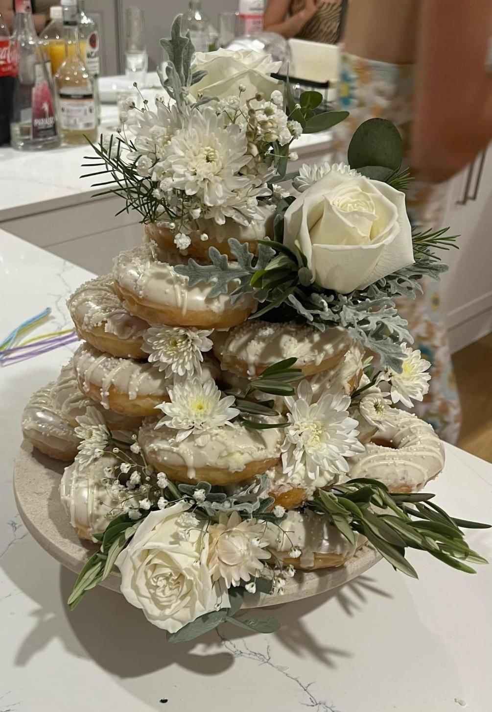 A Stack of Donuts Decorated With White Flowers on a Table — Flower Hunt in Robina, QLD