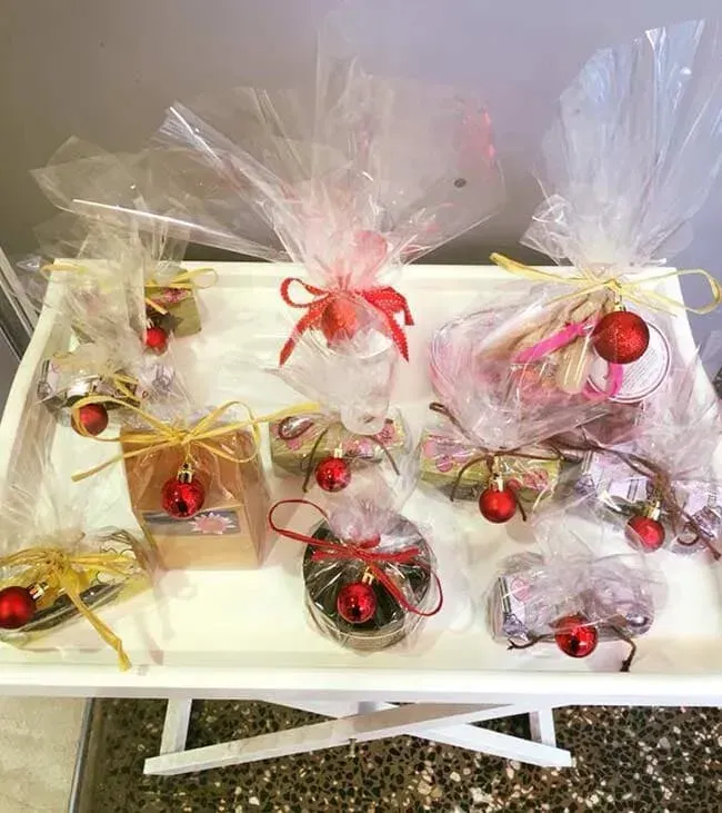A Table Topped With a Variety of Christmas Presents Wrapped in Plastic — Flower Hunt in Robina, QLD