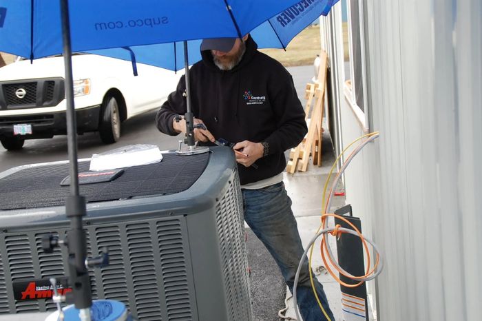 Man Fixing Aircon — Gresham, OR — Century Heating & A/C Inc.