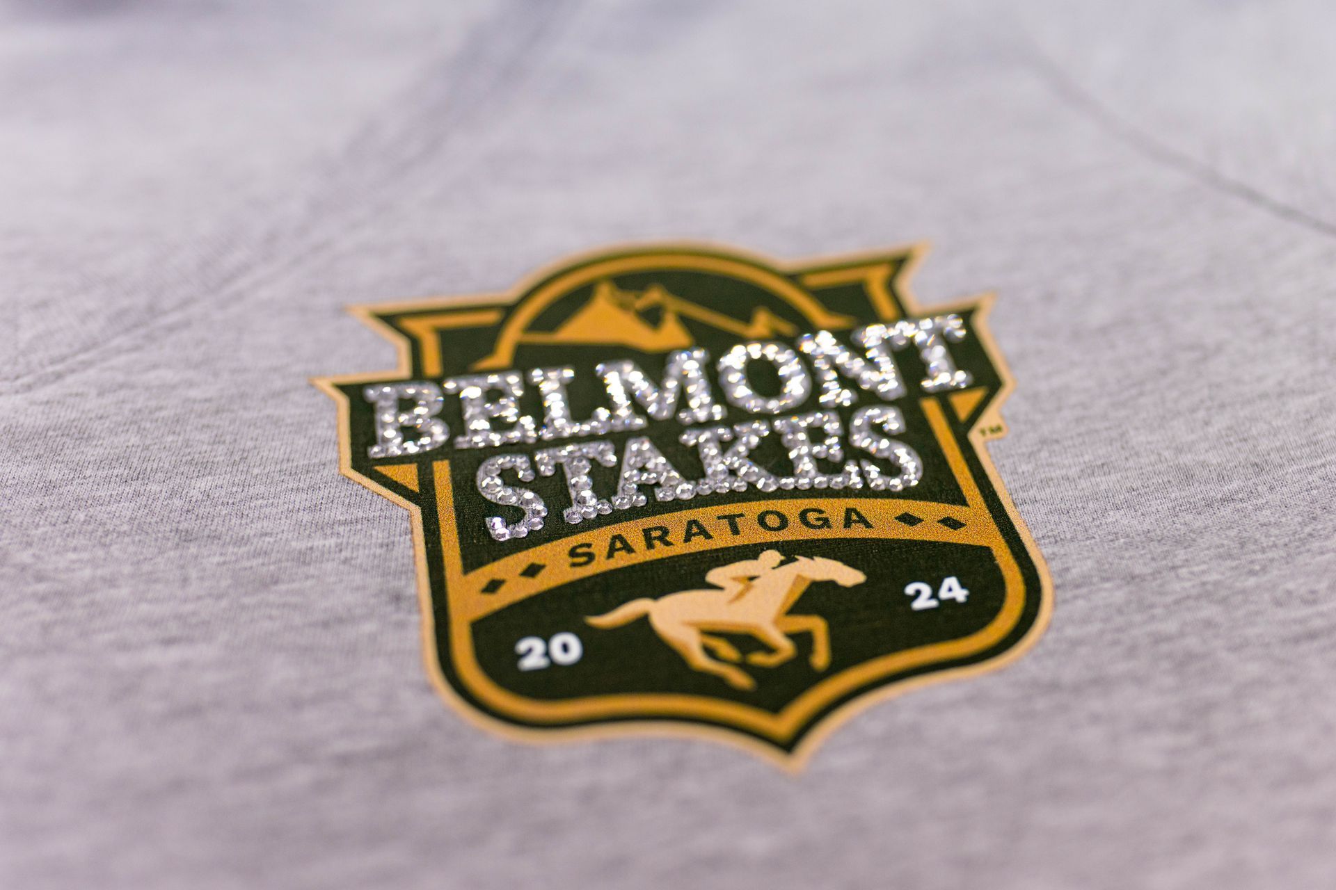 A close up of a belmont stakes logo on a shirt