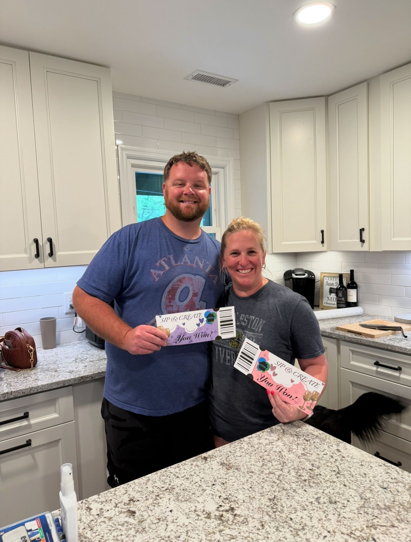 A man and a woman are posing for a picture in a kitchen.