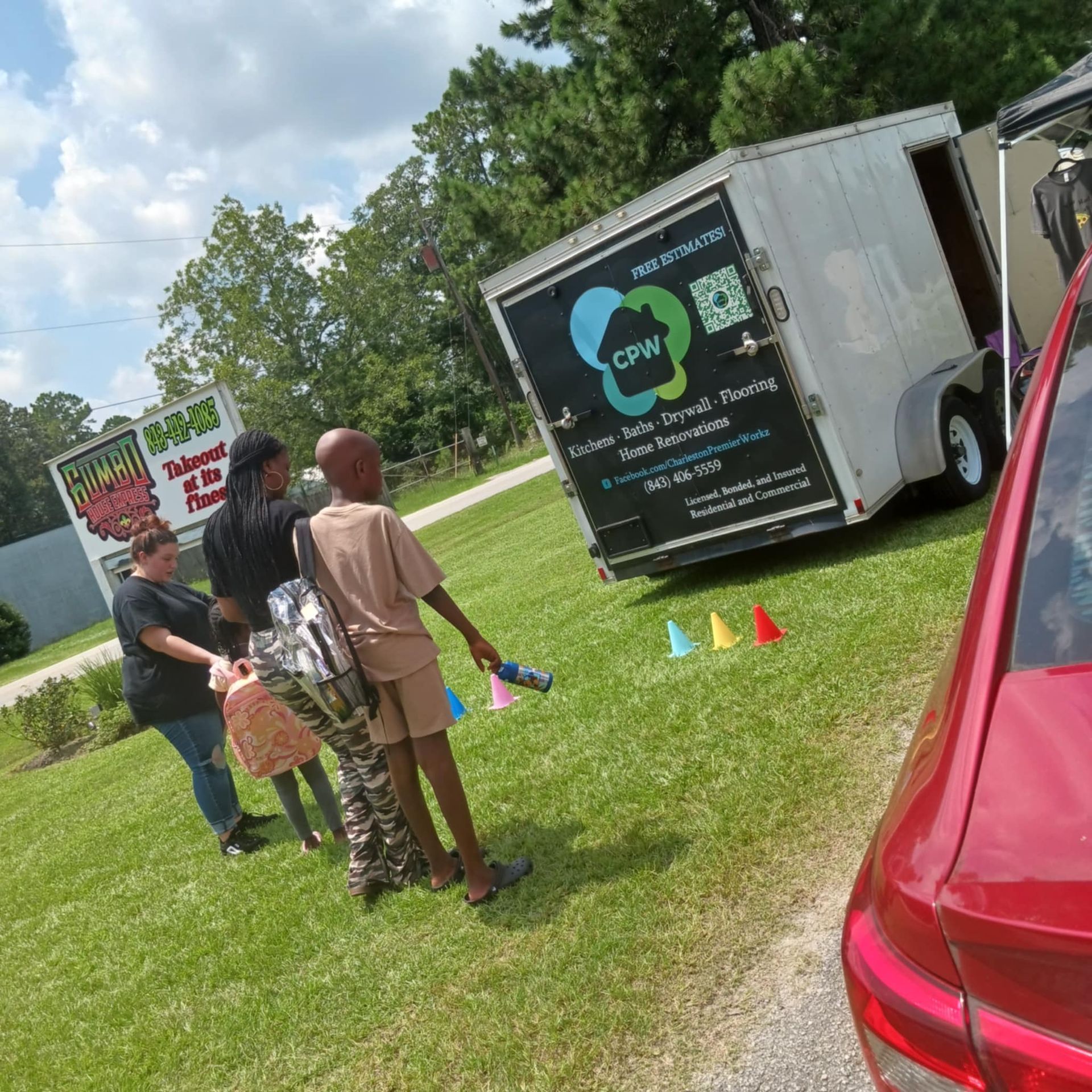 A group of people standing in front of a truck