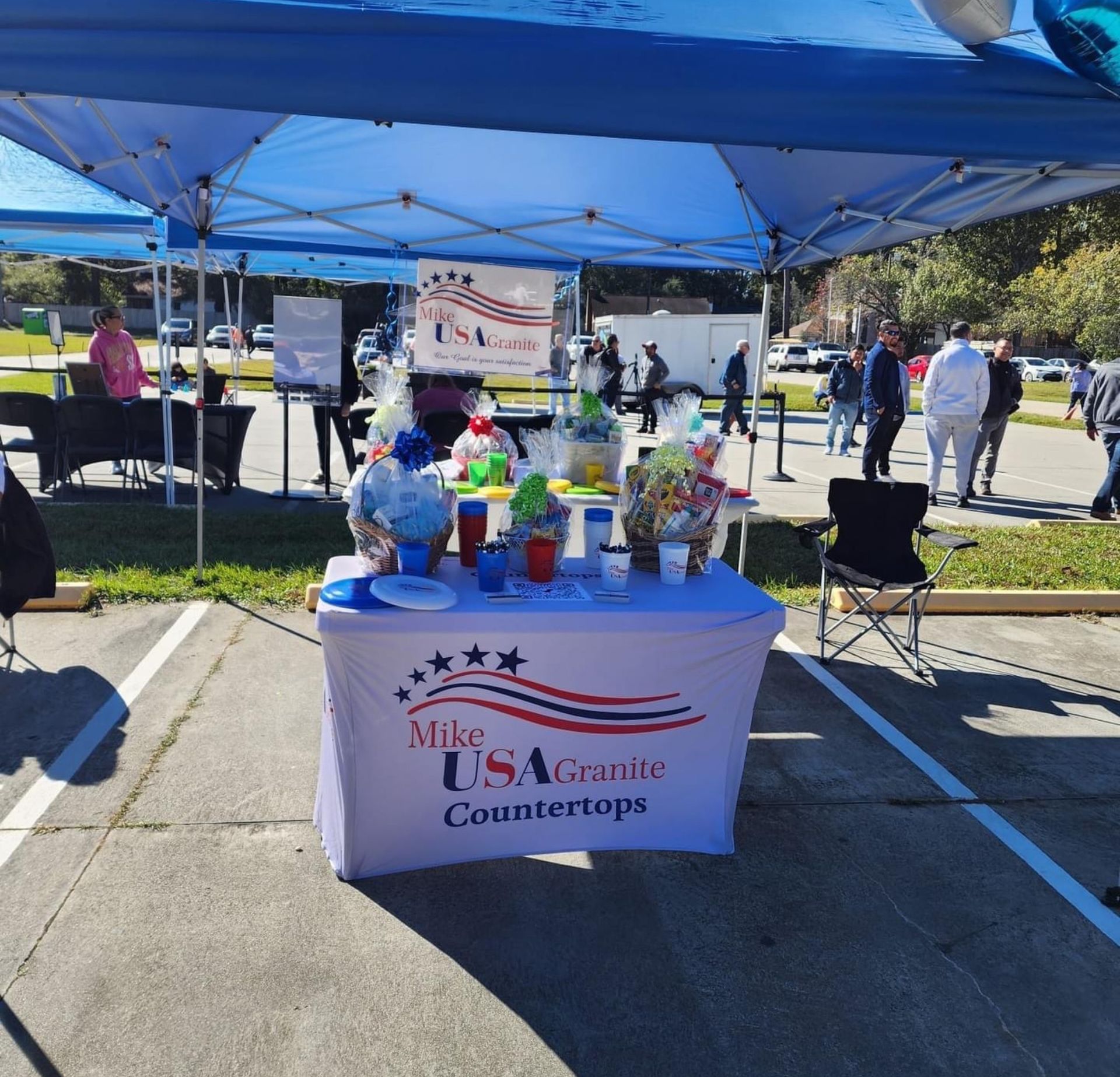 A table in a parking lot that says mike usa county countertops