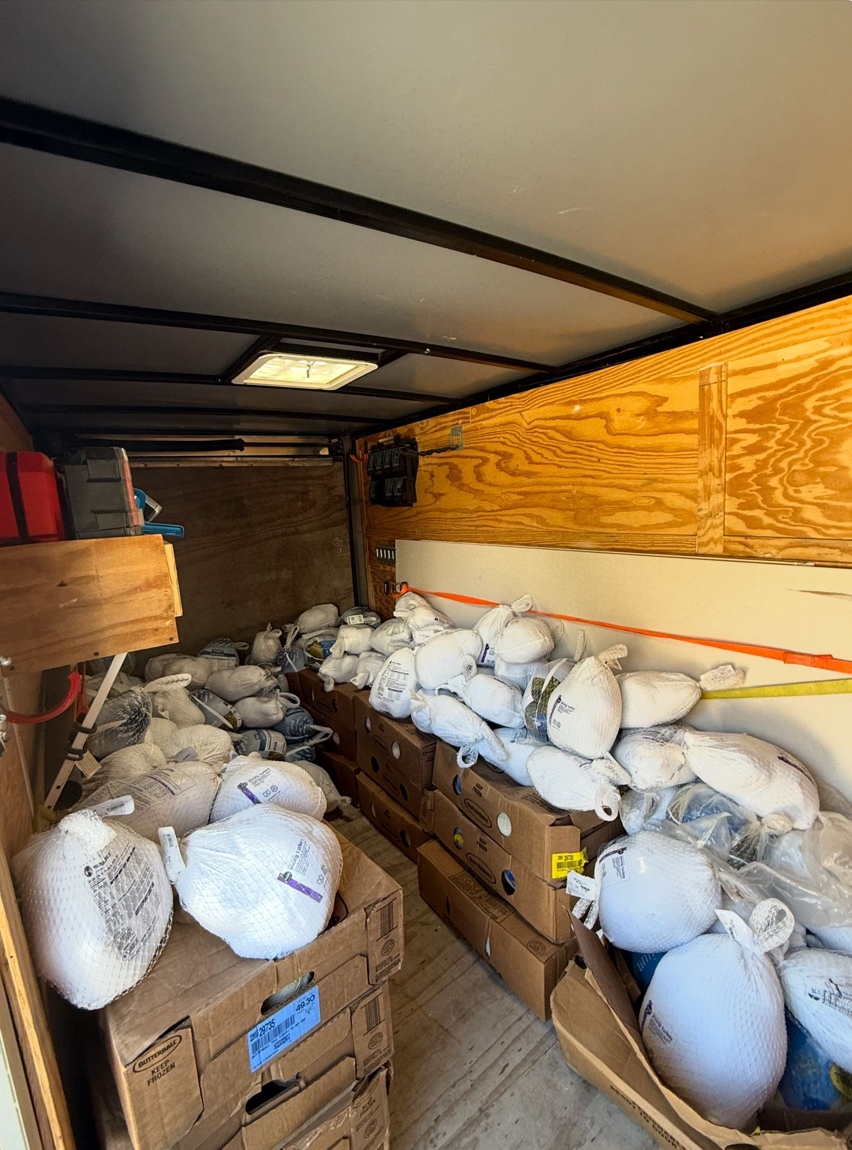 A trailer filled with lots of bags and boxes.