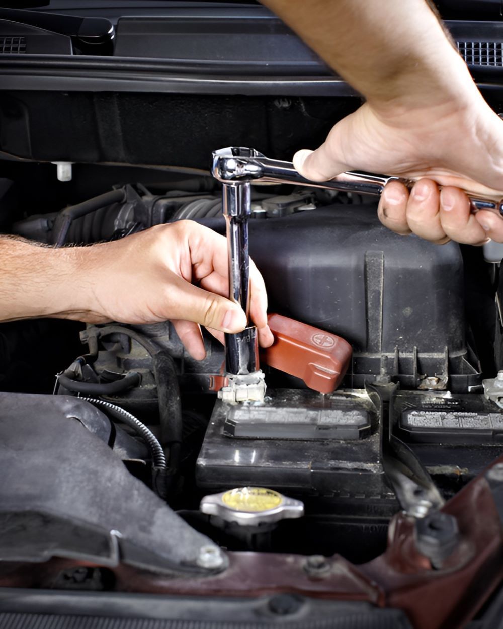 A Person Is Working On A Car Engine With A Wrench — Warrmech Mechanical In Tweed Heads South, NSW