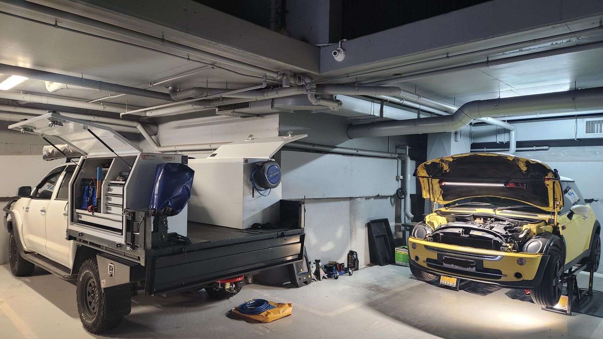 Two Cars Are Parked in a Garage With Their Hoods Open — Warrmech Mechanical In Tweed Heads South, NSW