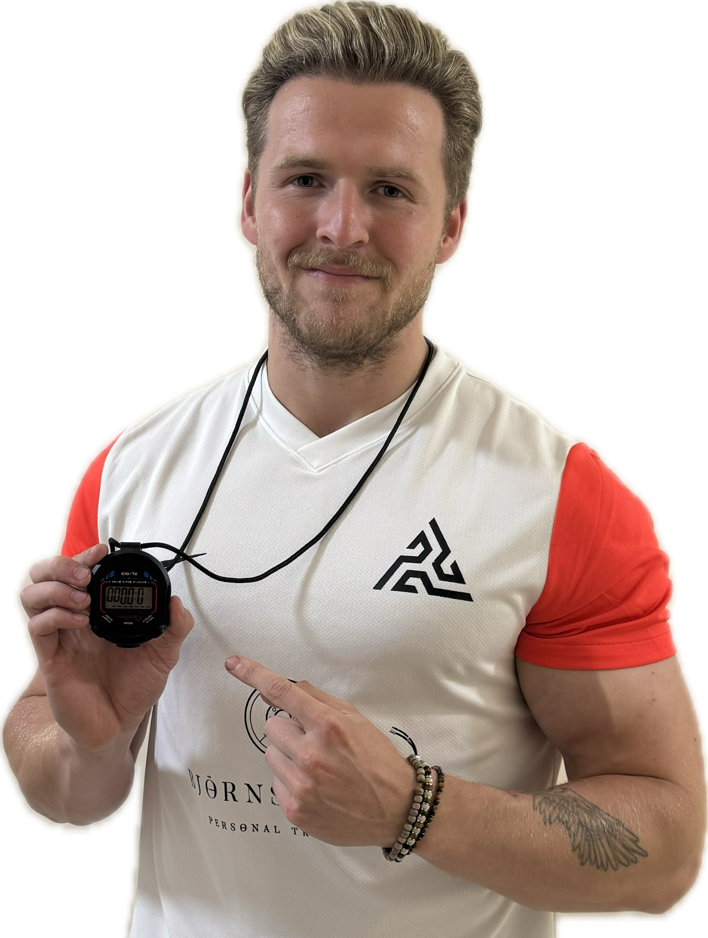 Woman in black workout clothes points to her side, smiling.