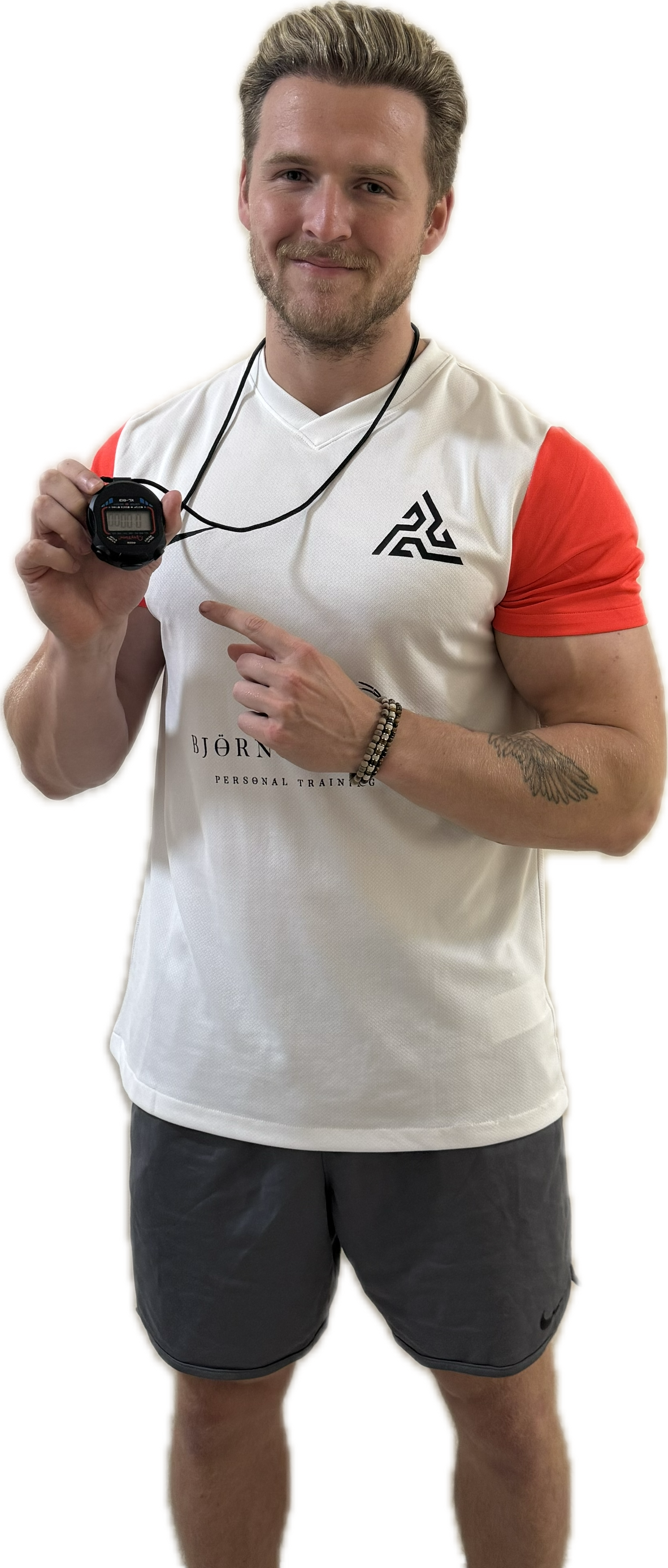 Man with blonde hair, wearing a white and orange t-shirt and gray shorts, holding and pointing at a stopwatch.