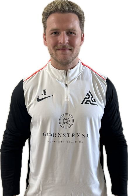 Man with blond hair in a white and black shirt with a logo, stands smiling.