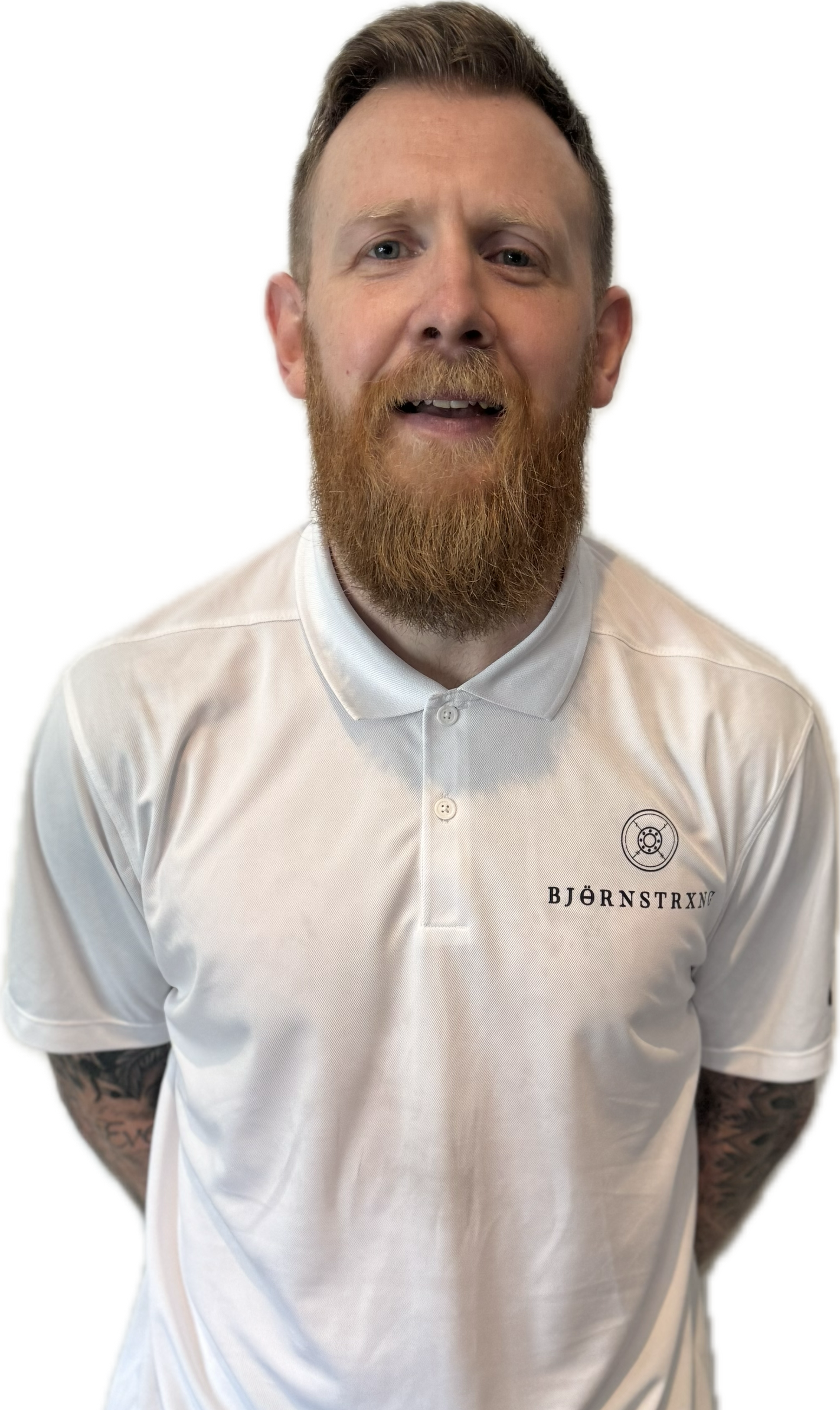 Man with red beard wearing white polo shirt, looking at the camera.