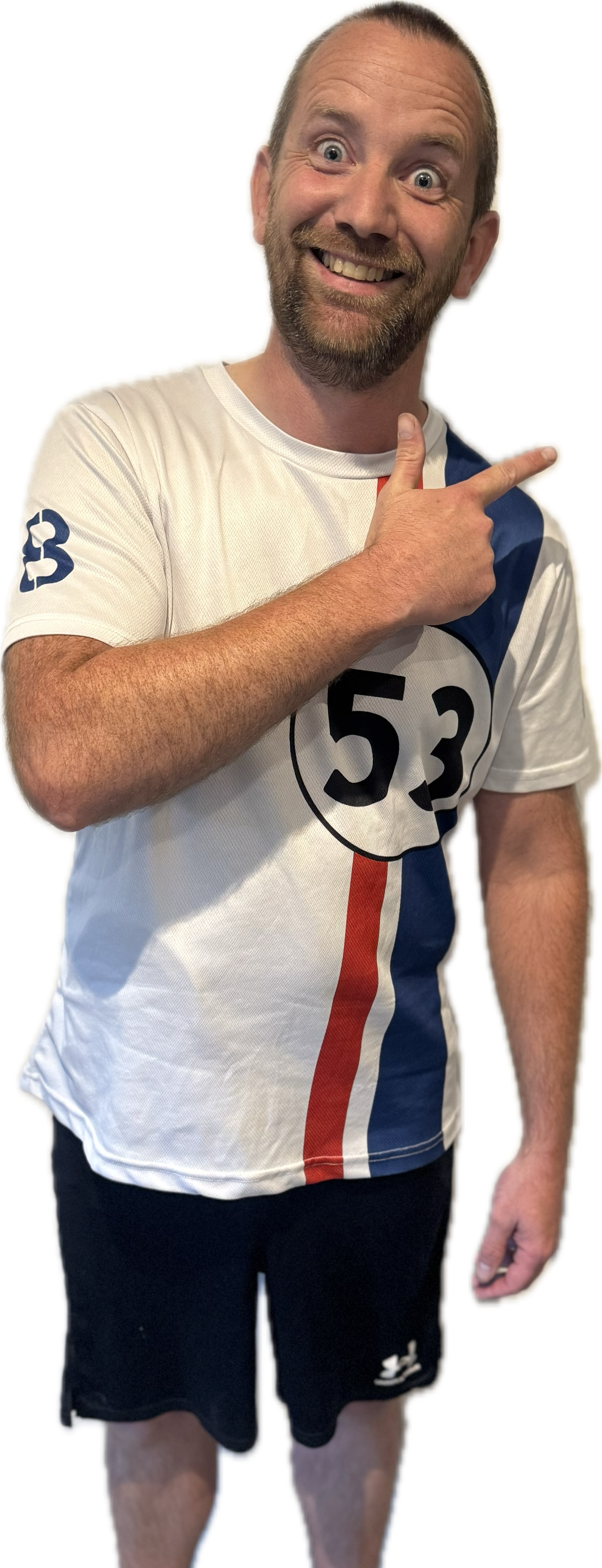 Man in white shirt and gray shorts smiles, stands against a white background.