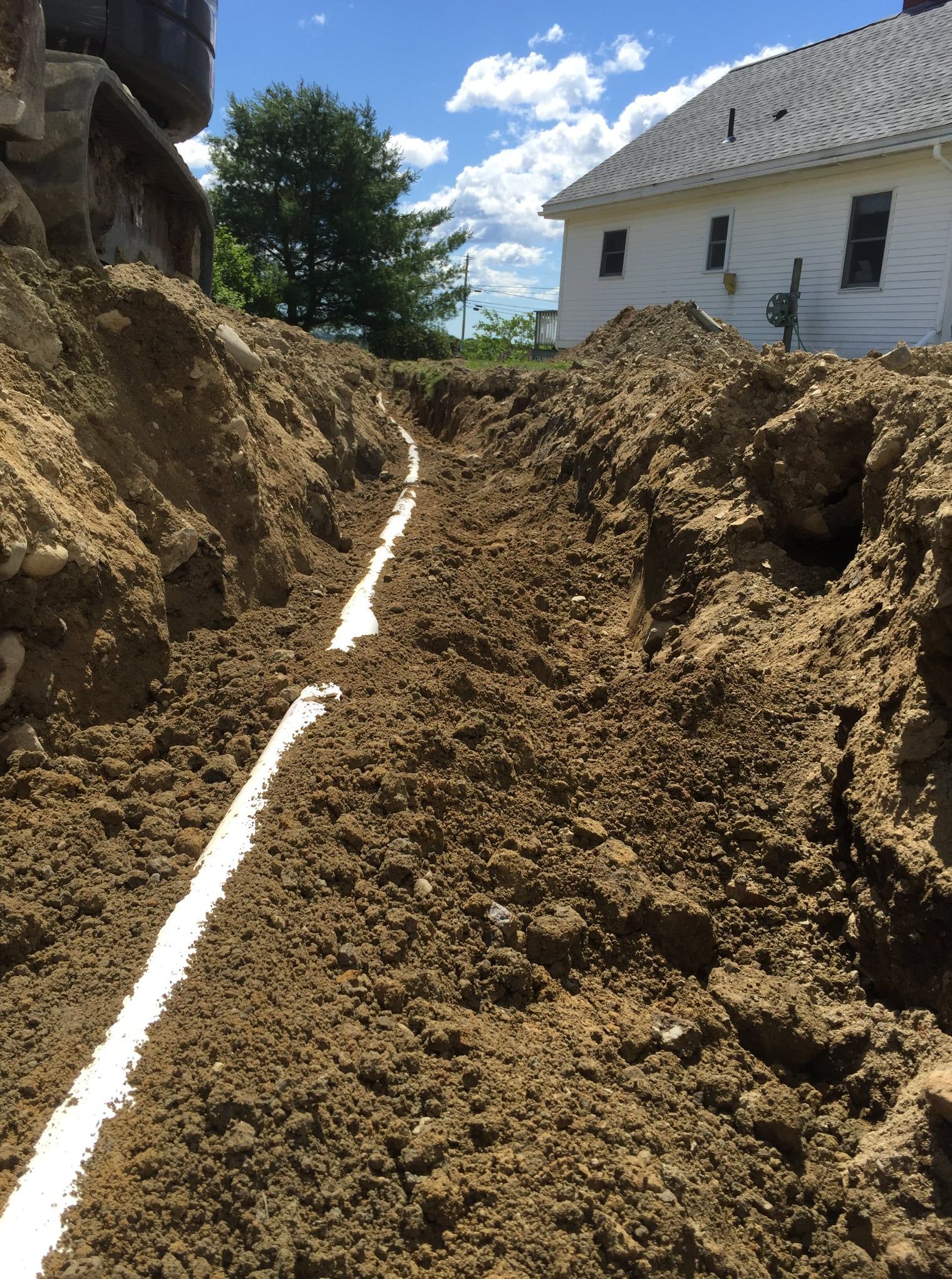 Two men are standing in an empty room with black walls