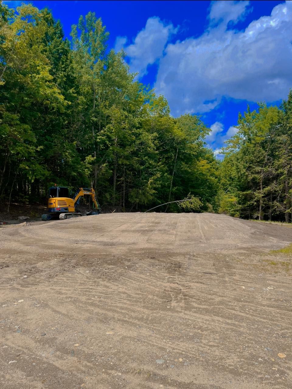 A white bathtub with beige tile walls and floor. A soap dish is mounted on the wall.