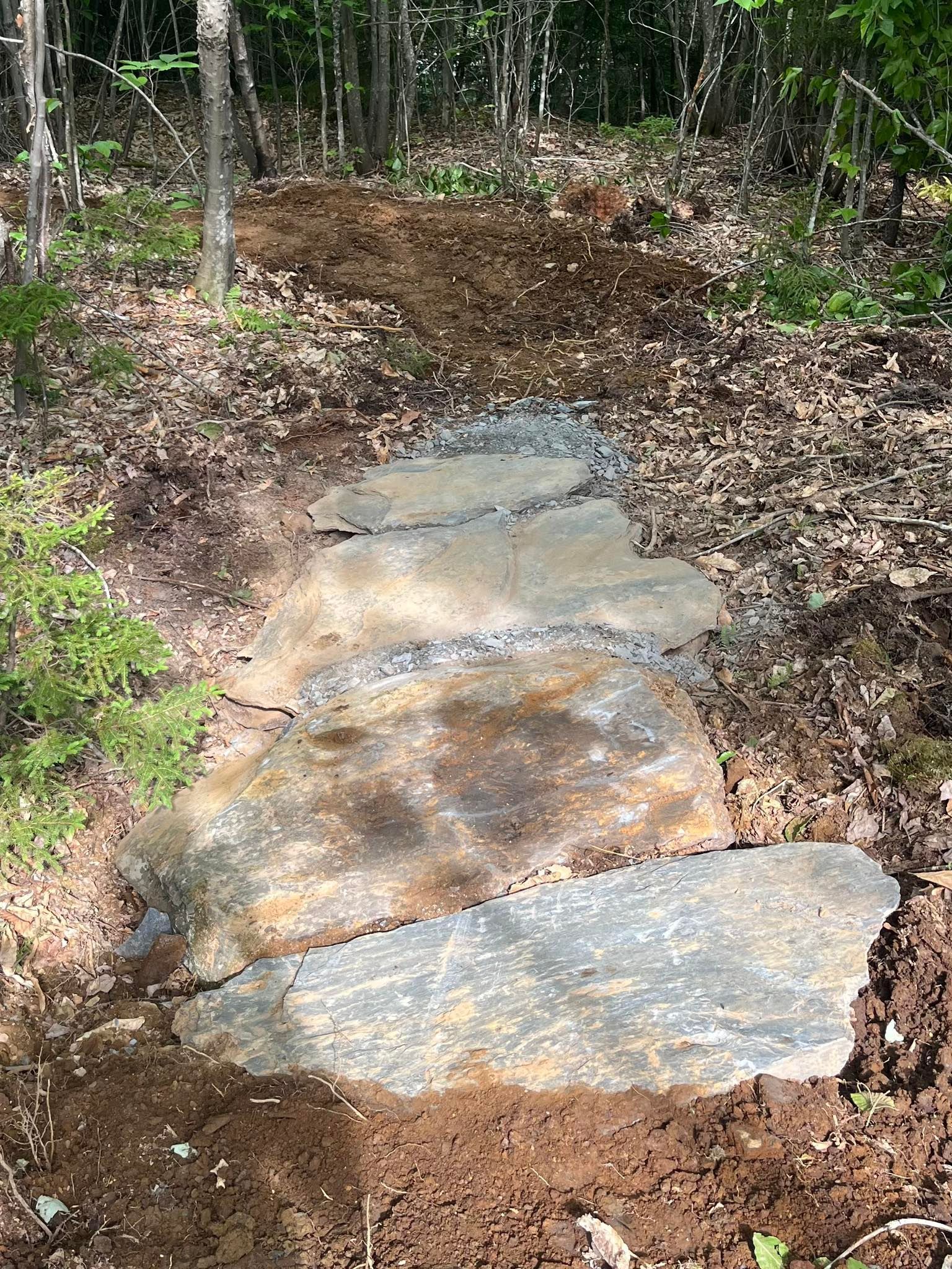 A white bathtub with beige tile walls and floor. A soap dish is mounted on the wall.