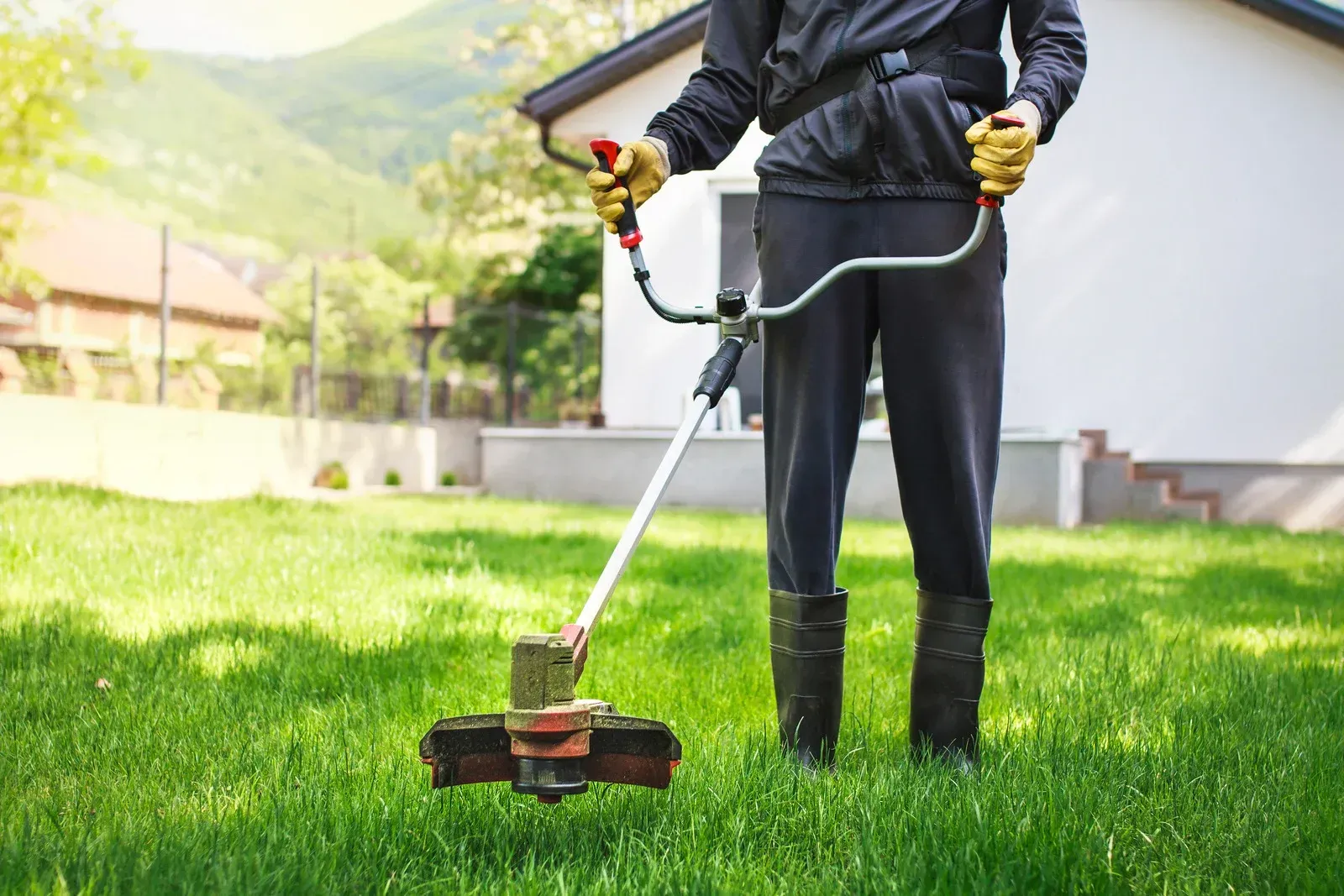 A white bathtub with beige tile walls and floor. A soap dish is mounted on the wall.
