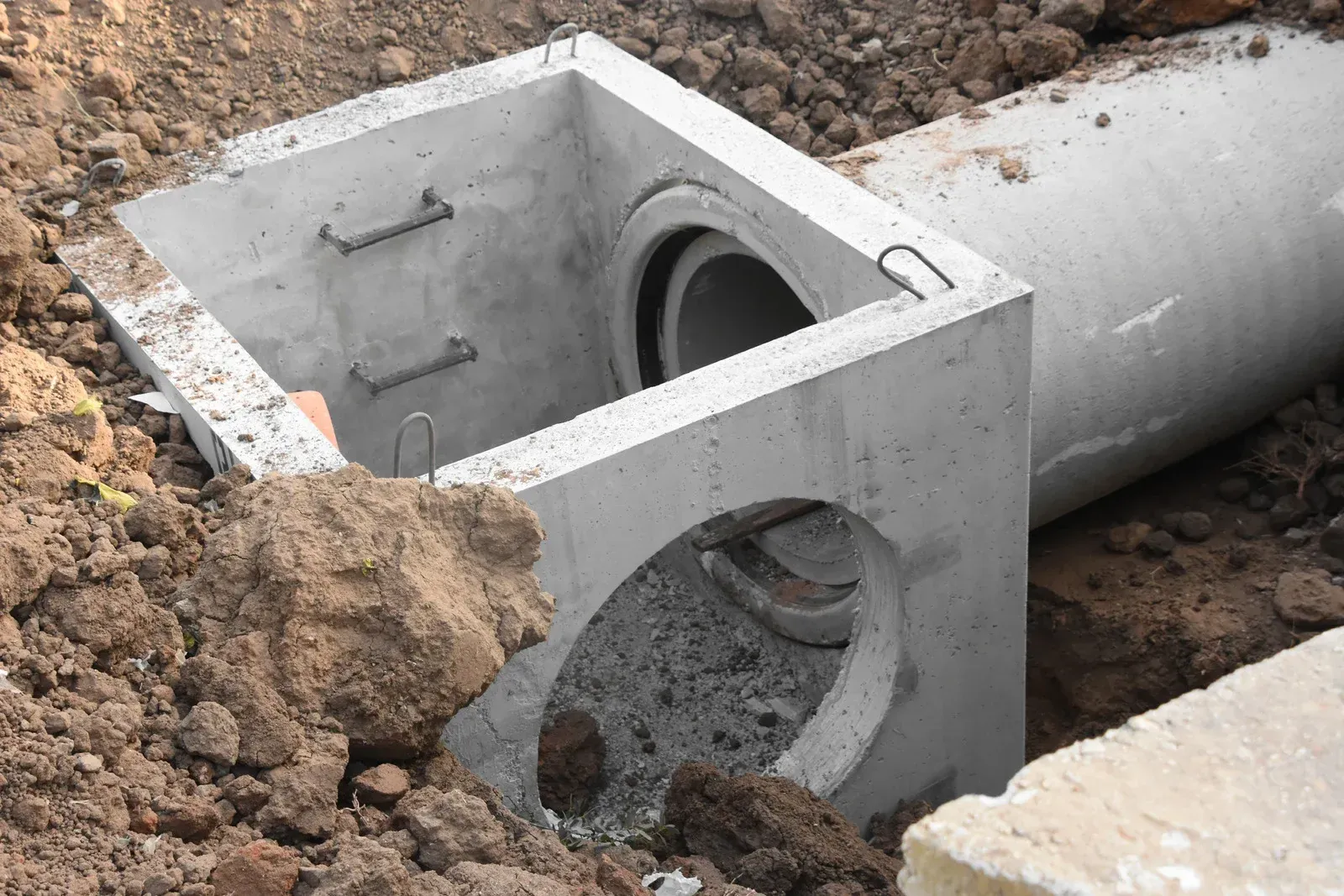 A white bathtub with beige tile walls and floor. A soap dish is mounted on the wall.