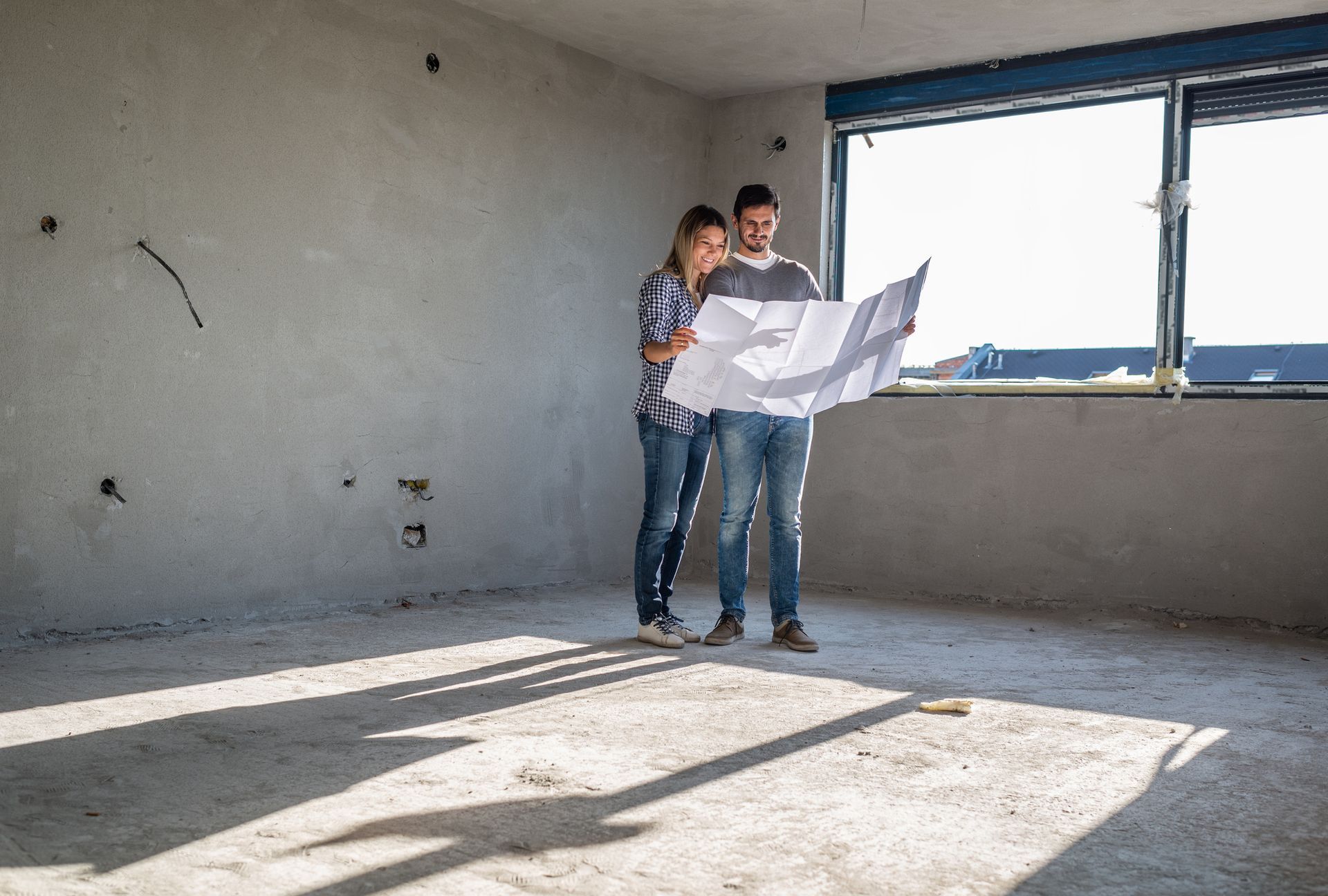 Couple in a room during demolition services in Troy, OH, for spring cleaning Couple in a room during demolition services in Troy, OH, for spring cleaning