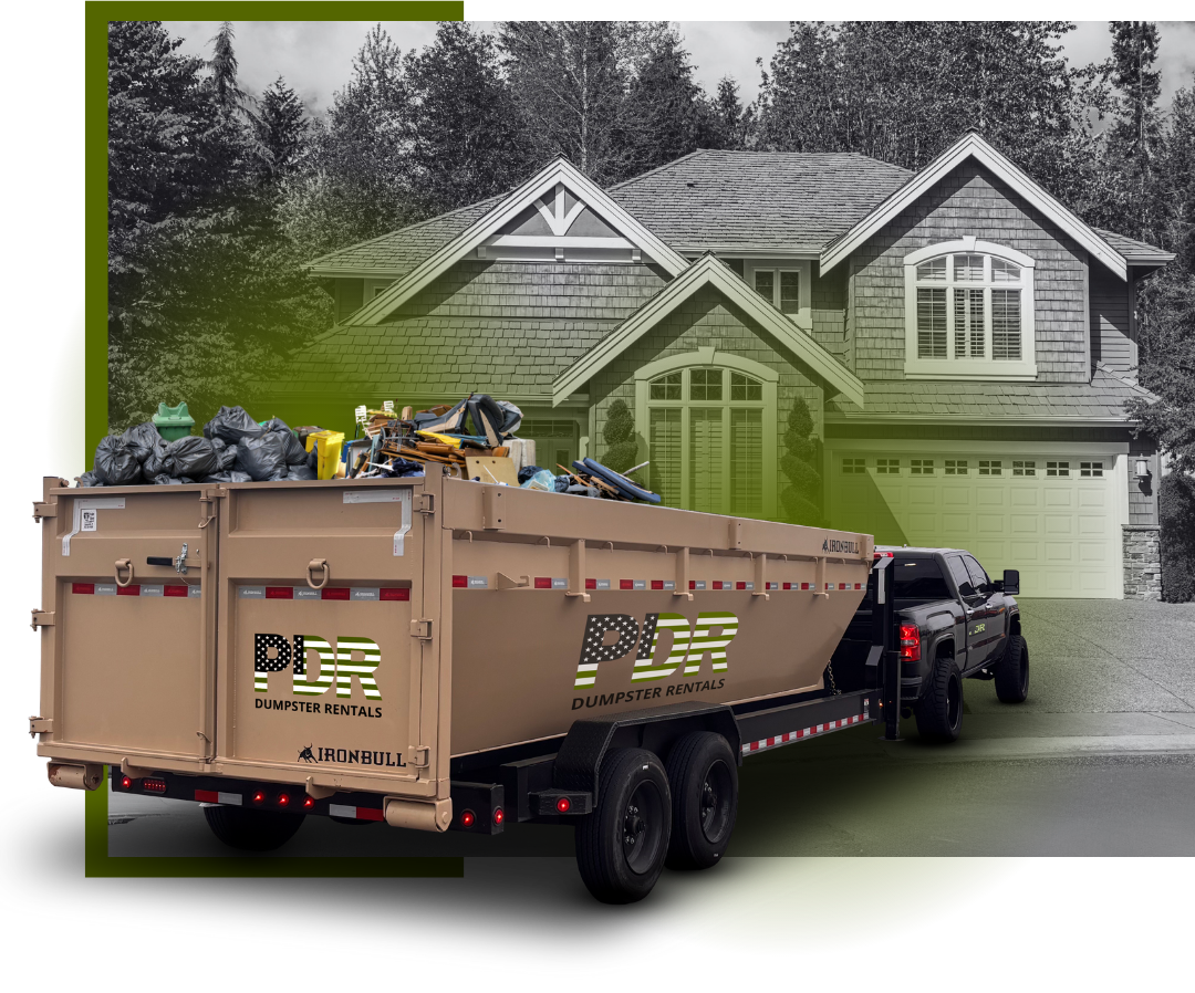 A PDR dumpster truck in front of a house