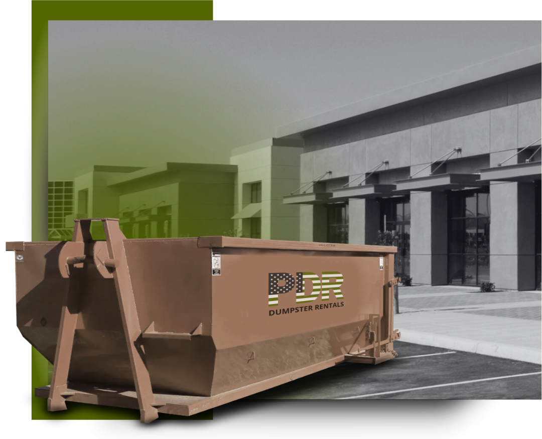 A PDR dumpster truck in front of a a commercial building