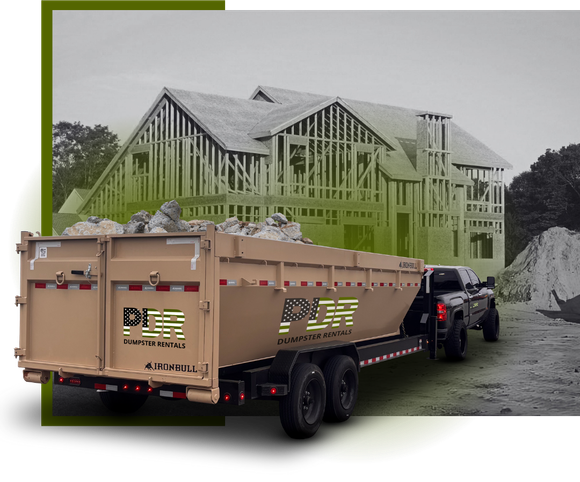 A PDR dumpster truck in front a house construction