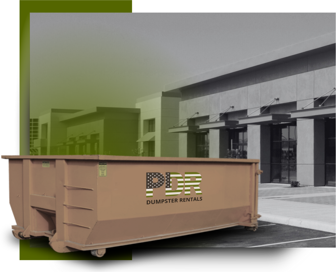 A PDR dumpster truck in front of a a commercial building