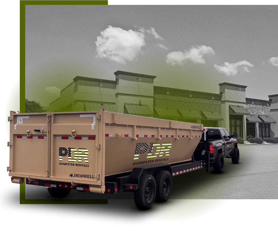 A PDR Dumpster truck in front a commercial building