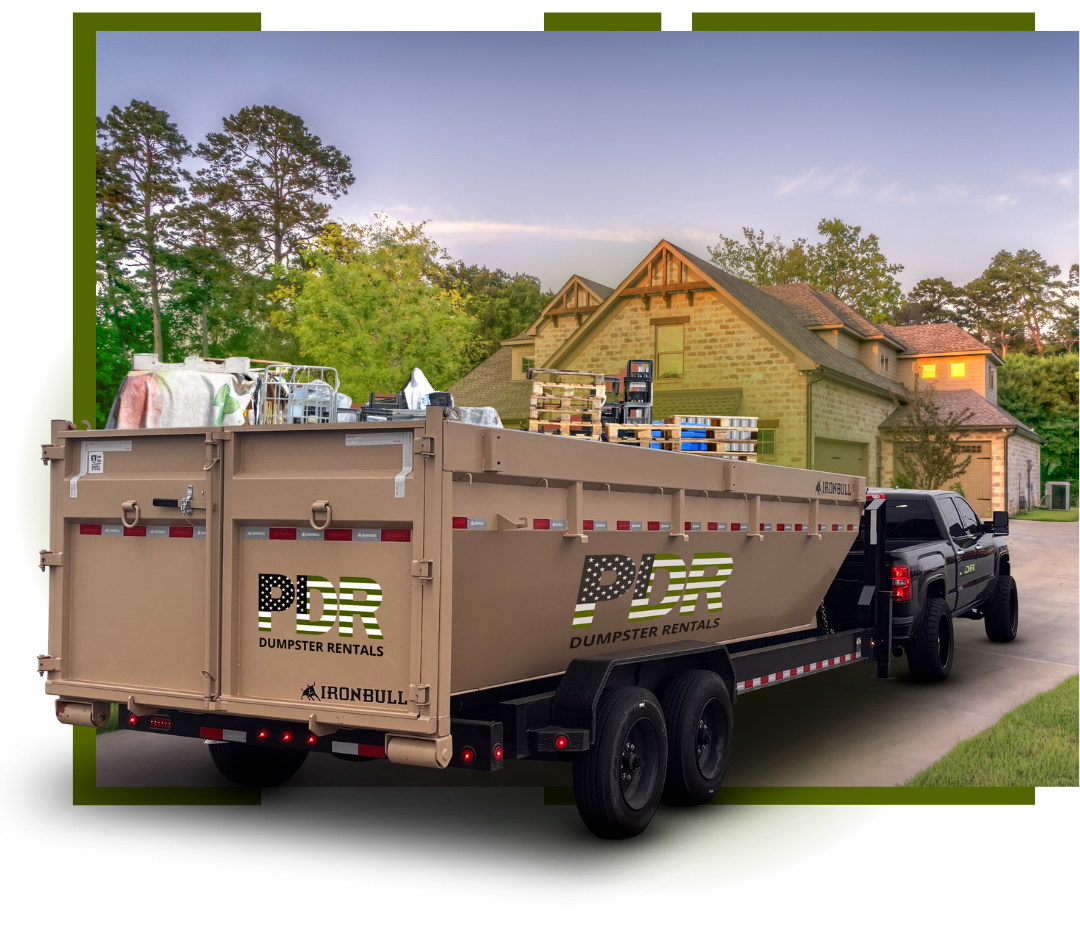 A PDR Dumpster truck parked n front of a house