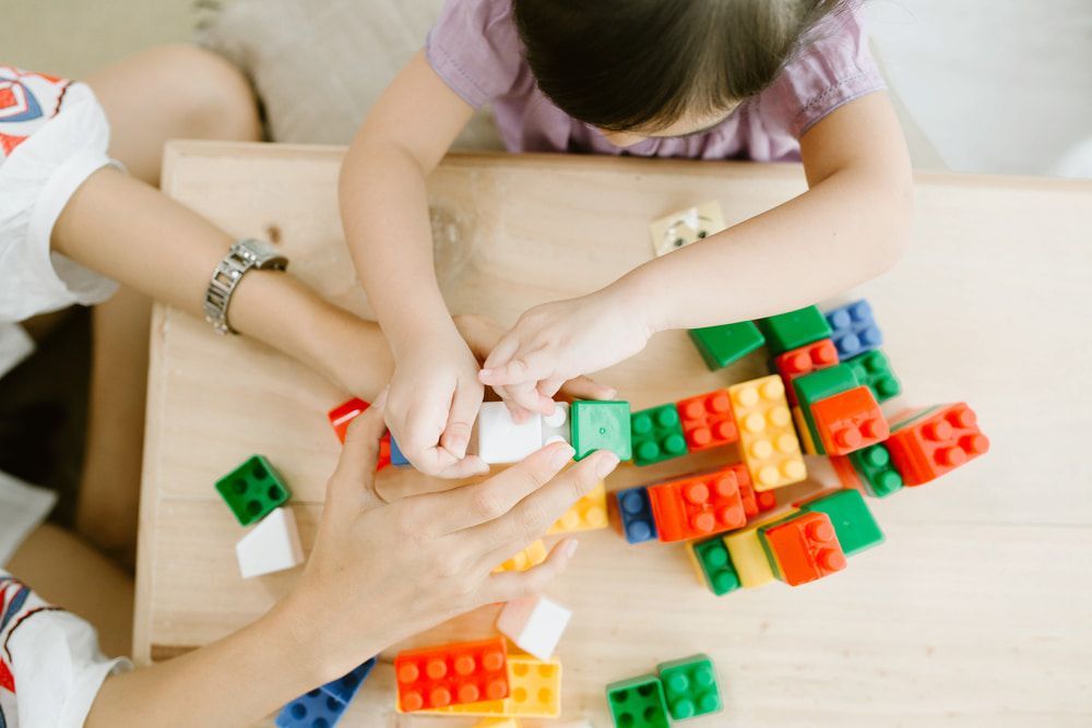 A Woman and a Child Are Playing With Lego Blocks at a Table — Mt Ousley Pre School in Fairy Meadow, NSW