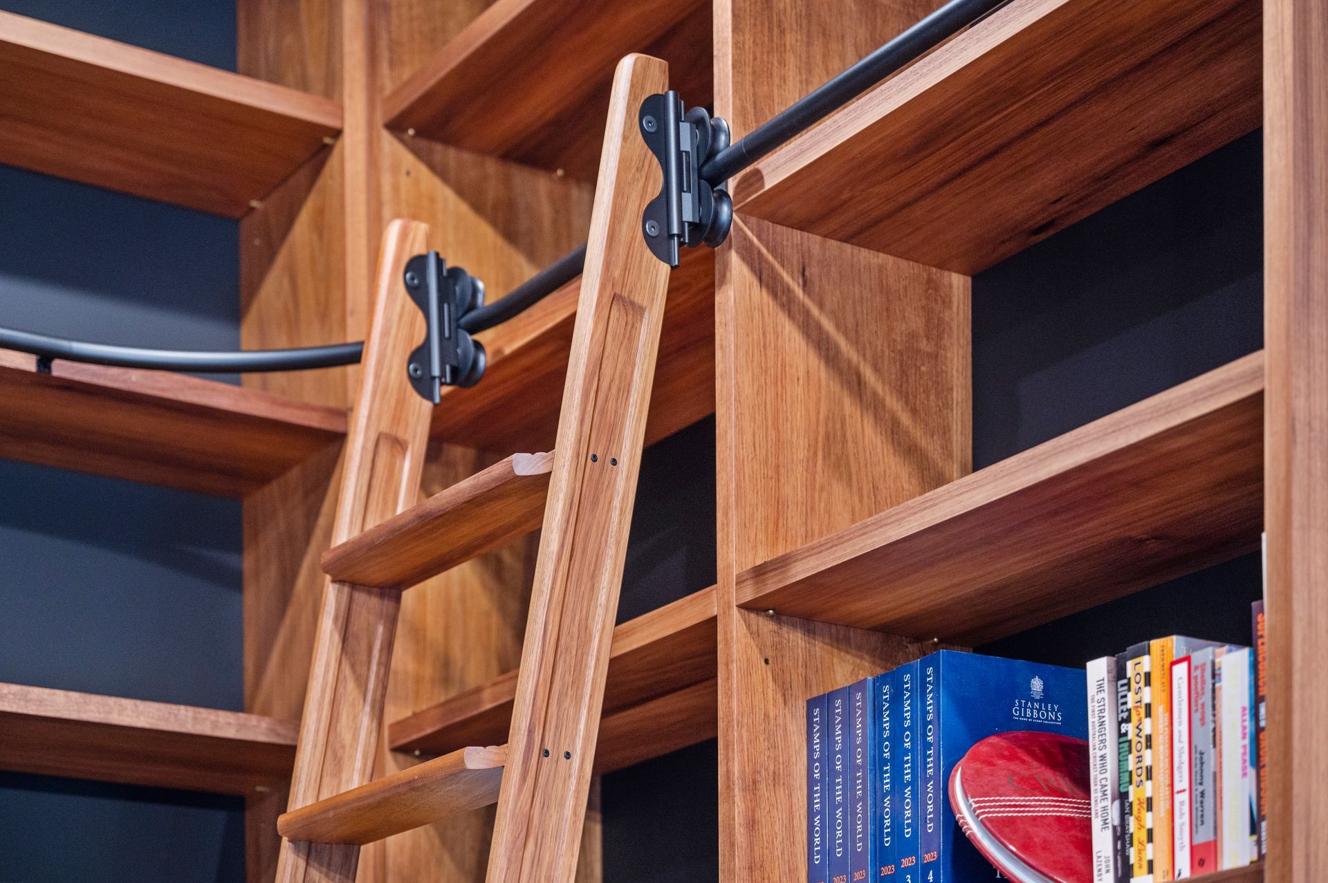 A Wooden Ladder is Attached to a Wooden Bookshelf — Plumbe Joinery in Coffs Harbour, NSW