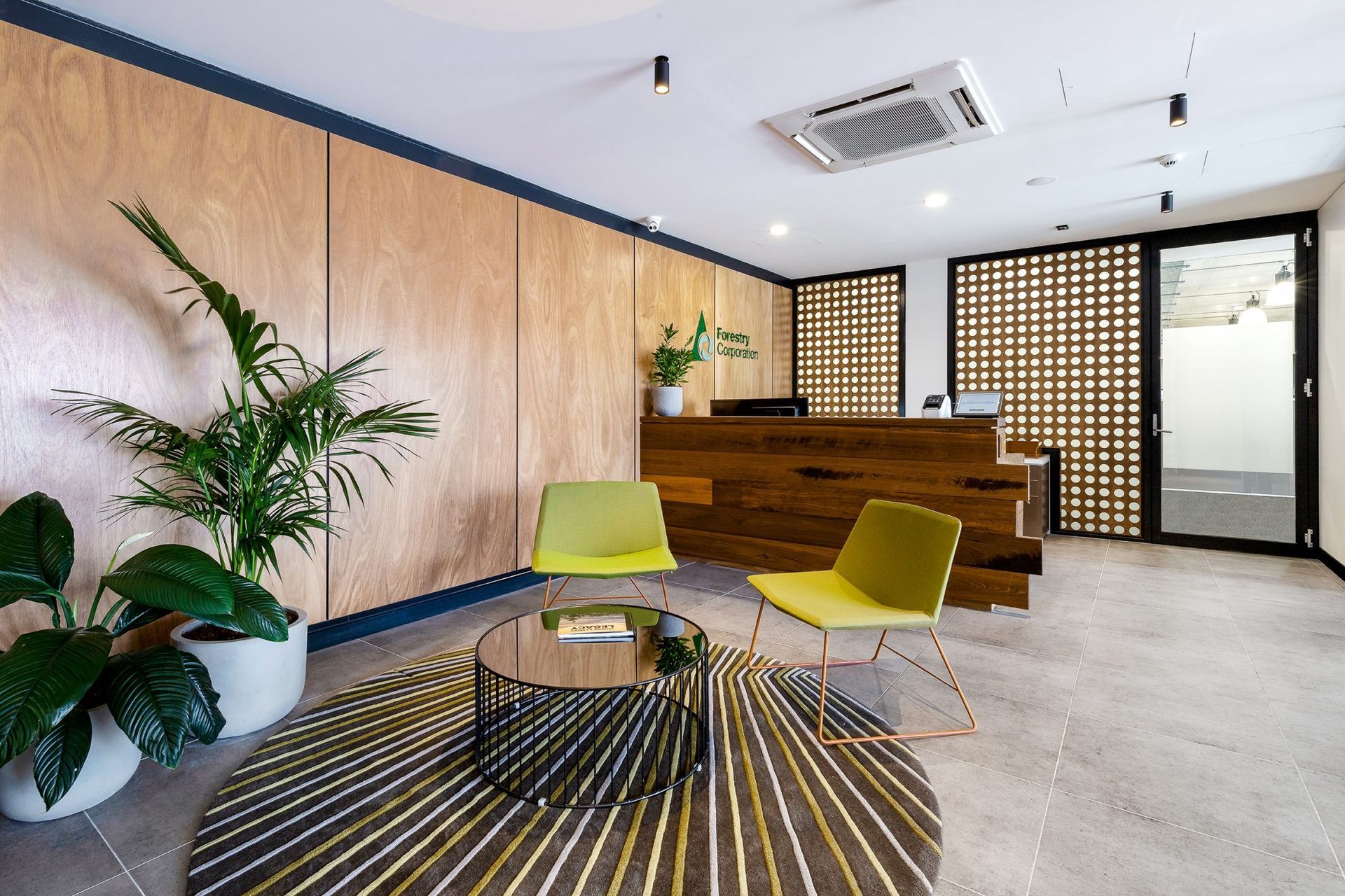 A Living Room With Chairs, a Table and a Rug — Plumbe Joinery in Coffs Harbour, NSW