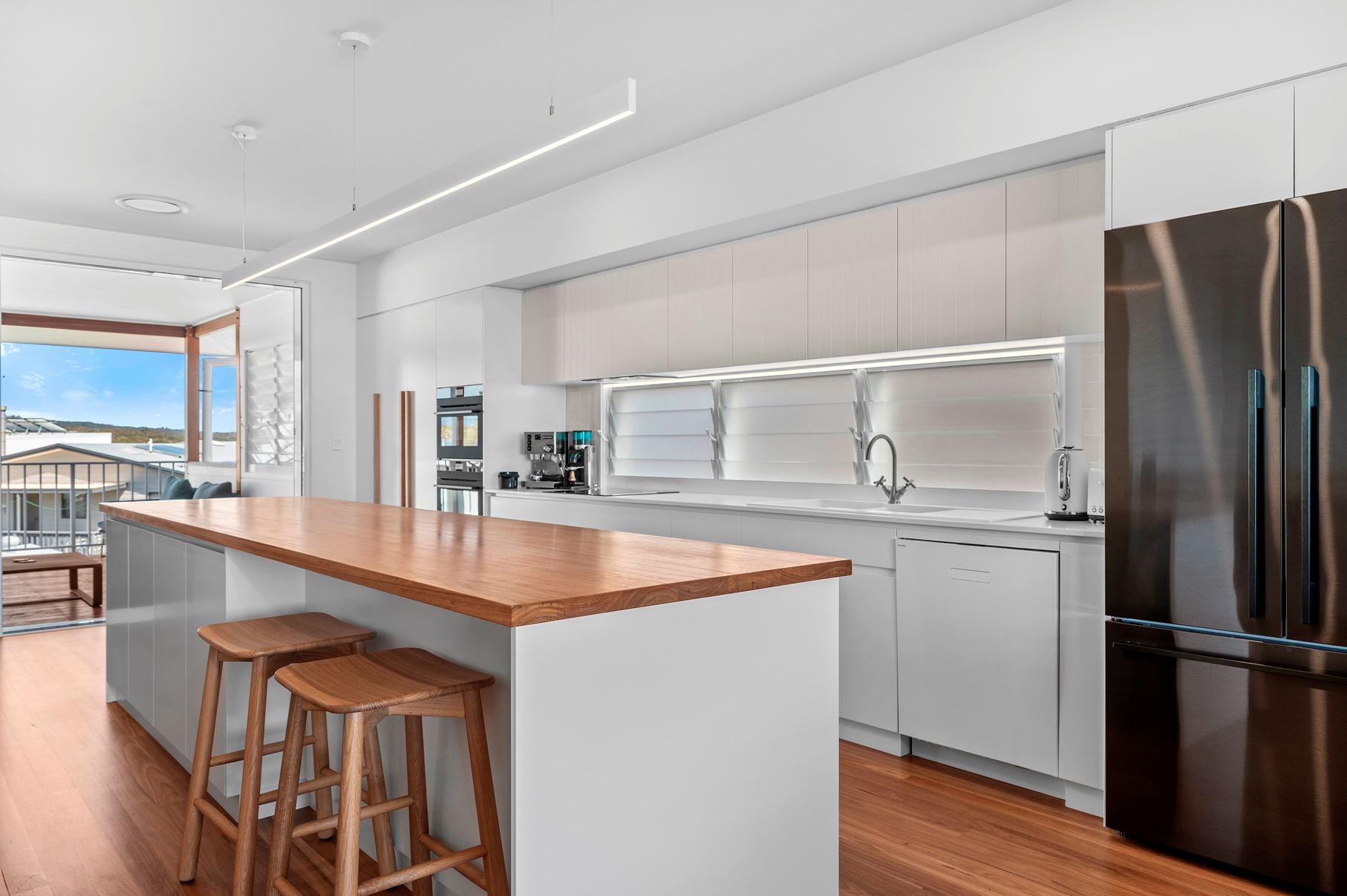 A Kitchen With White Cabinets — Plumbe Joinery in Coffs Harbour, NSW