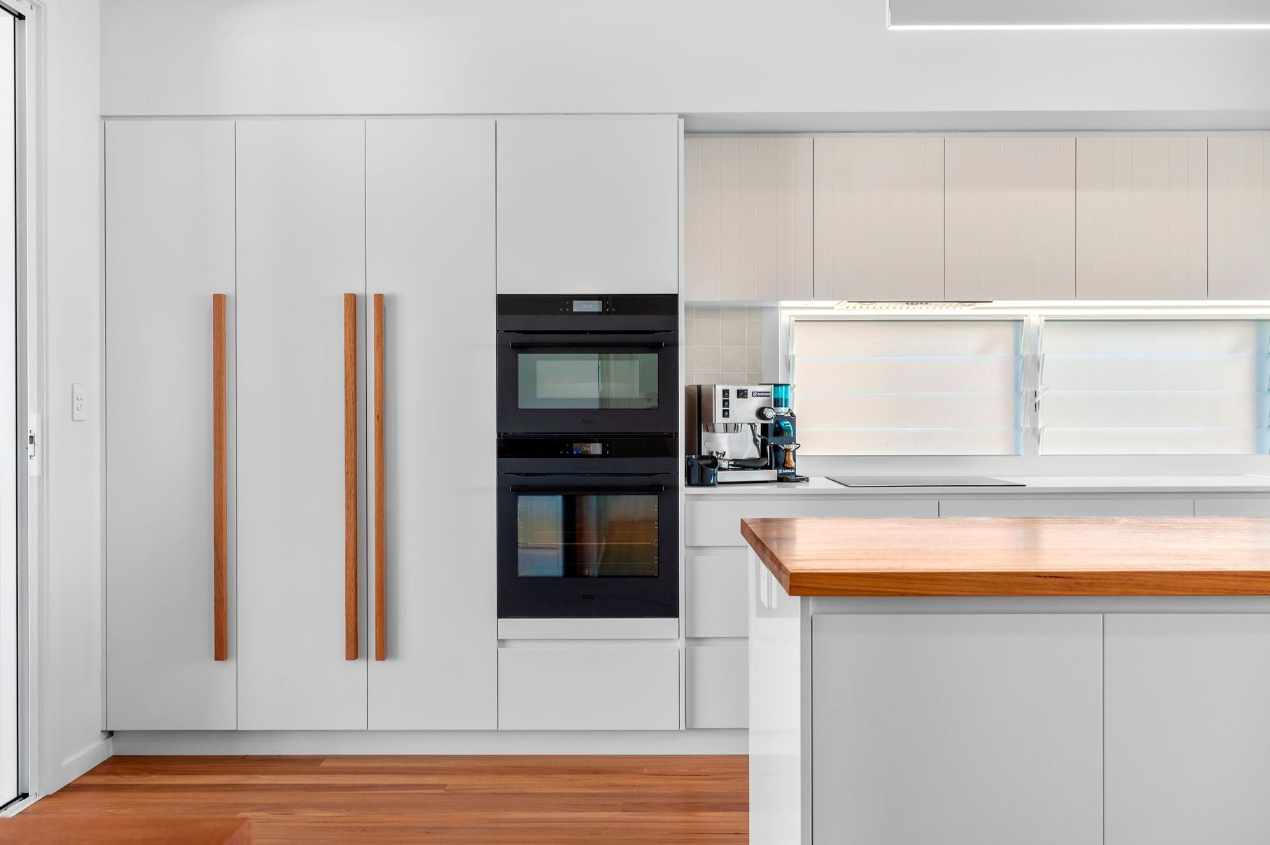 Kitchen With White Cabinets and Wooden Countertops — Plumbe Joinery in Coffs Harbour, NSW