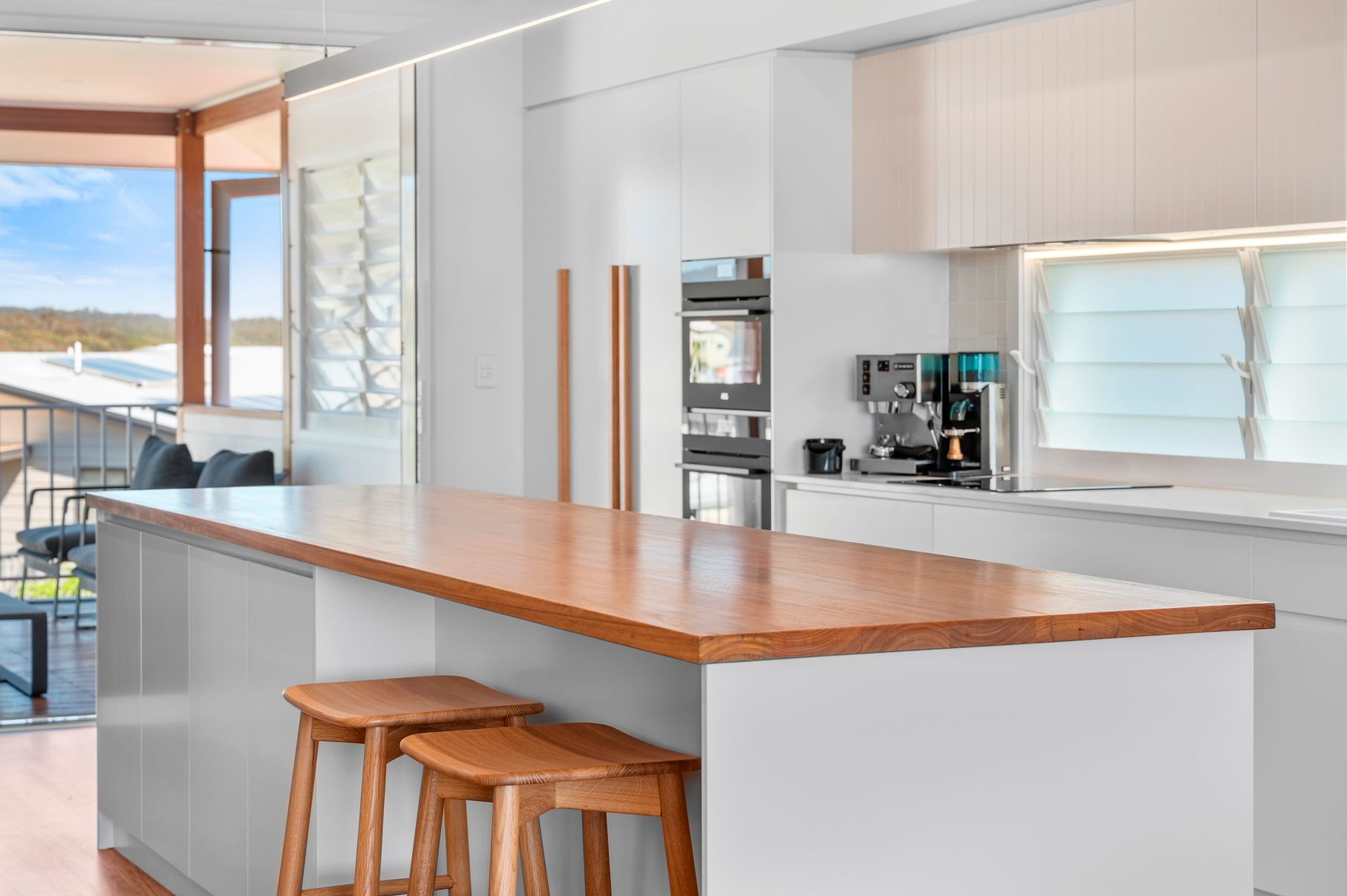 A Kitchen With White Cabinets, and Wooden Counter Tops — Plumbe Joinery in Coffs Harbour, NSW