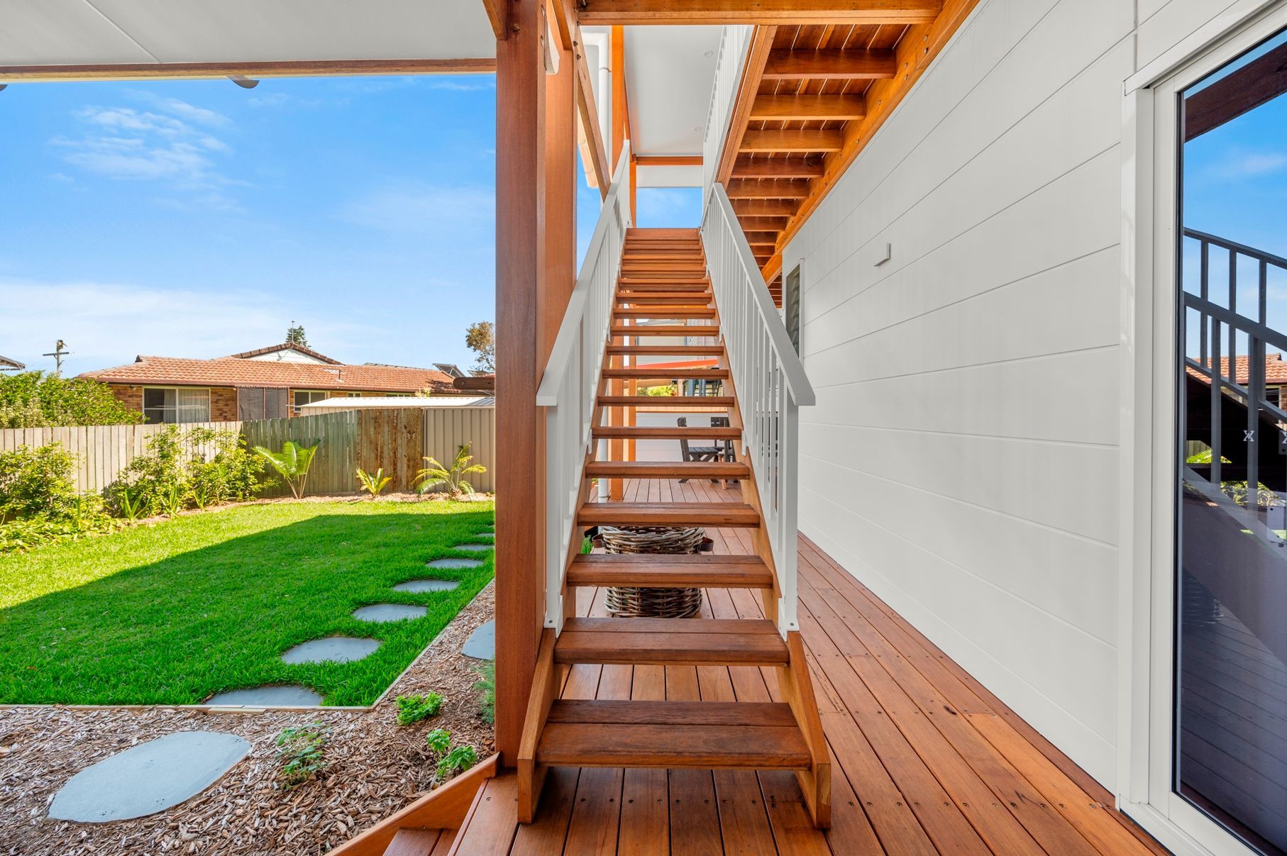 A Wooden Deck With Stairs Leading Up to the Second Floor of a House — Plumbe Joinery in Coffs Harbour, NSW