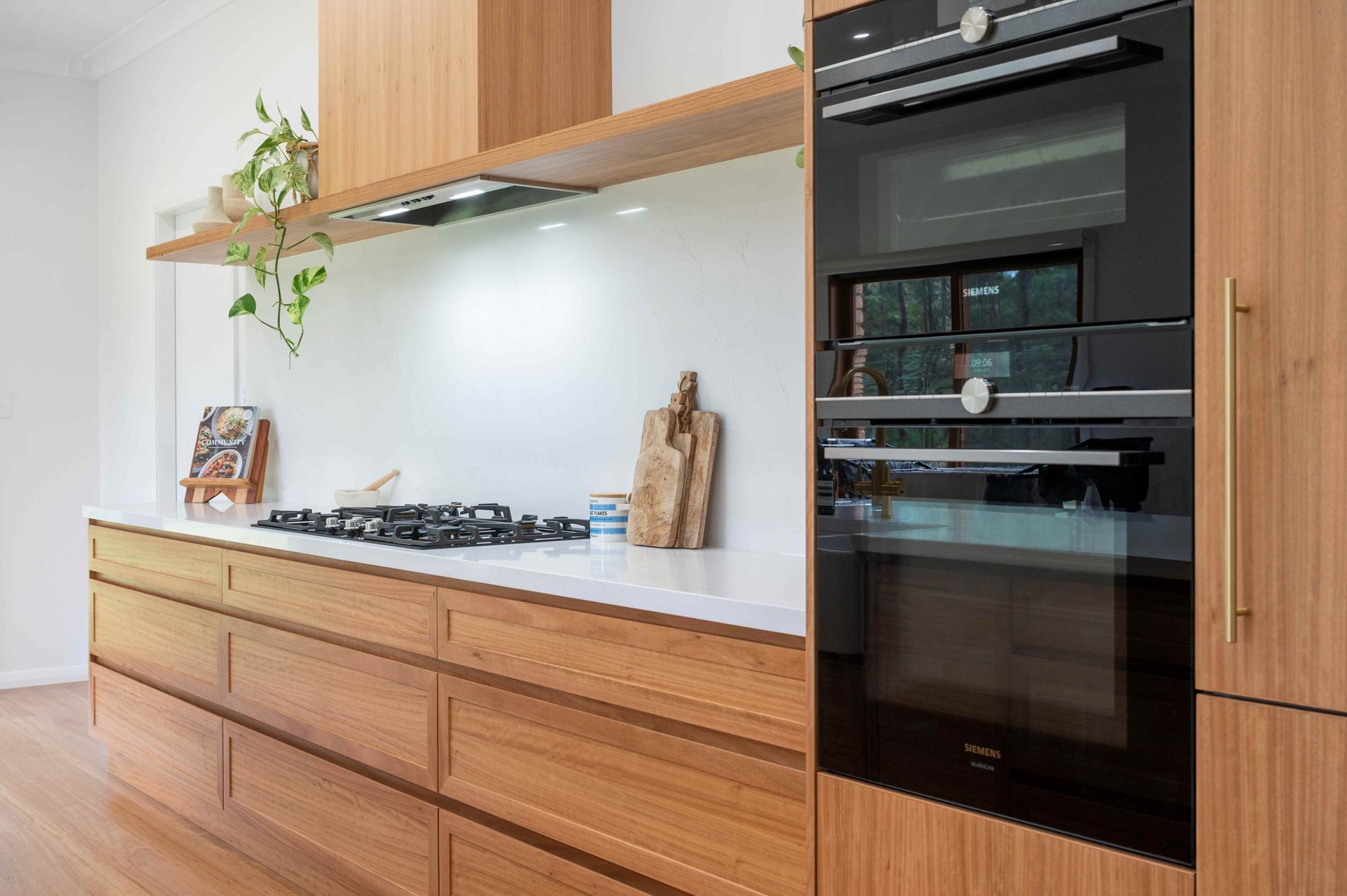 A Kitchen With Wooden Cabinets — Plumbe Joinery in Coffs Harbour, NSW